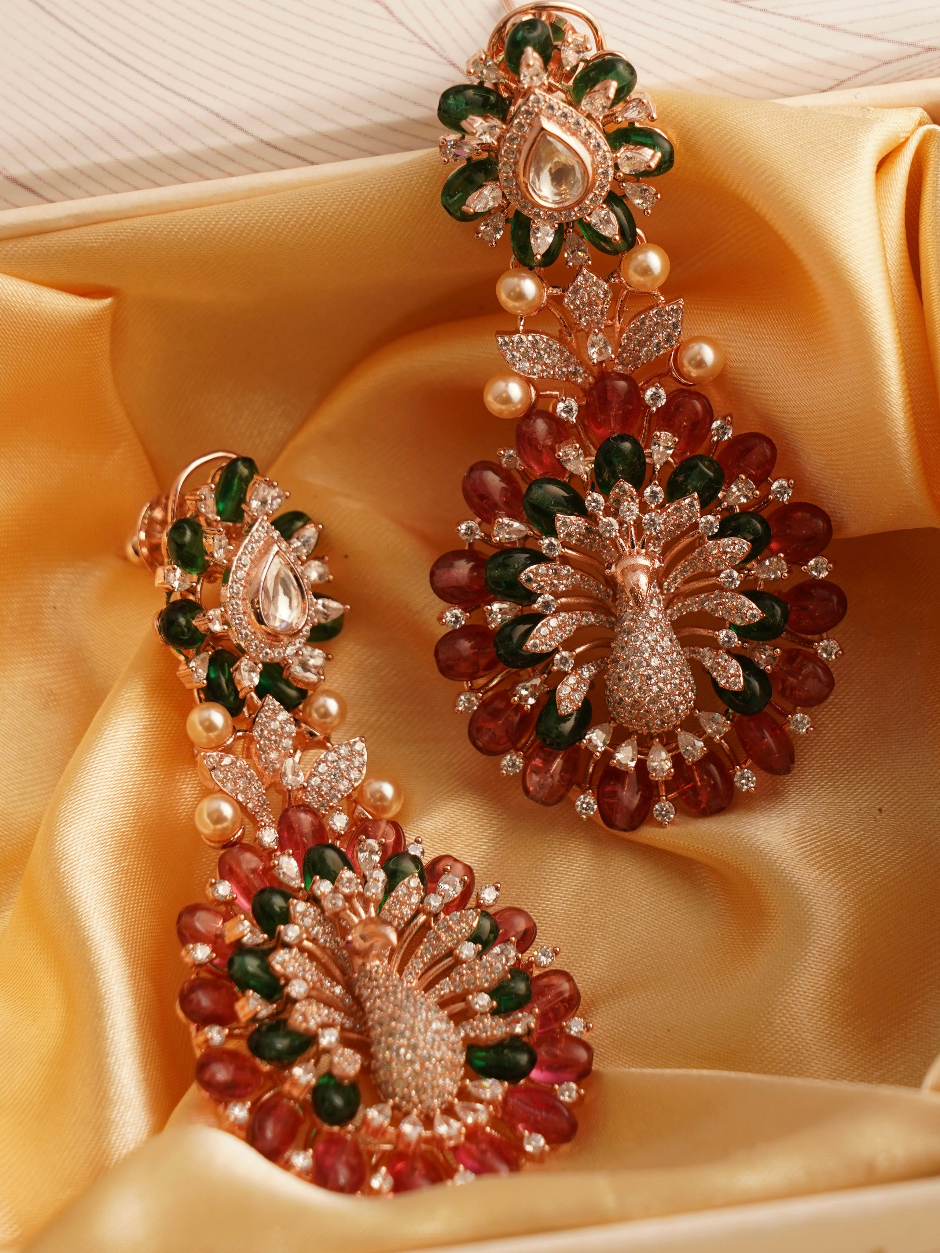 side profile of dancing peacock earrings with diamond finish and fresh color hues