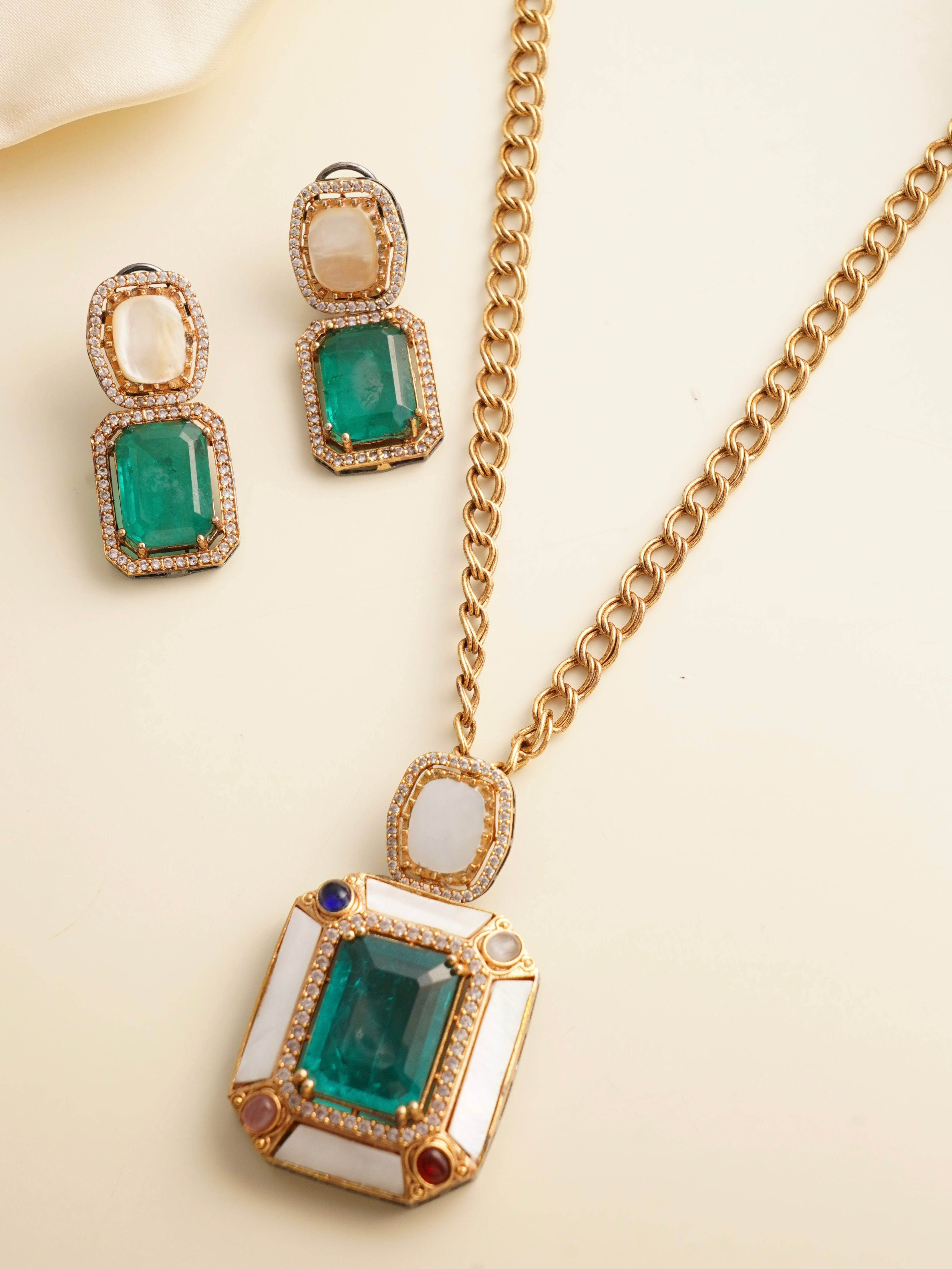 Close-up of emerald pendant highlighting intricate setting and color contrast