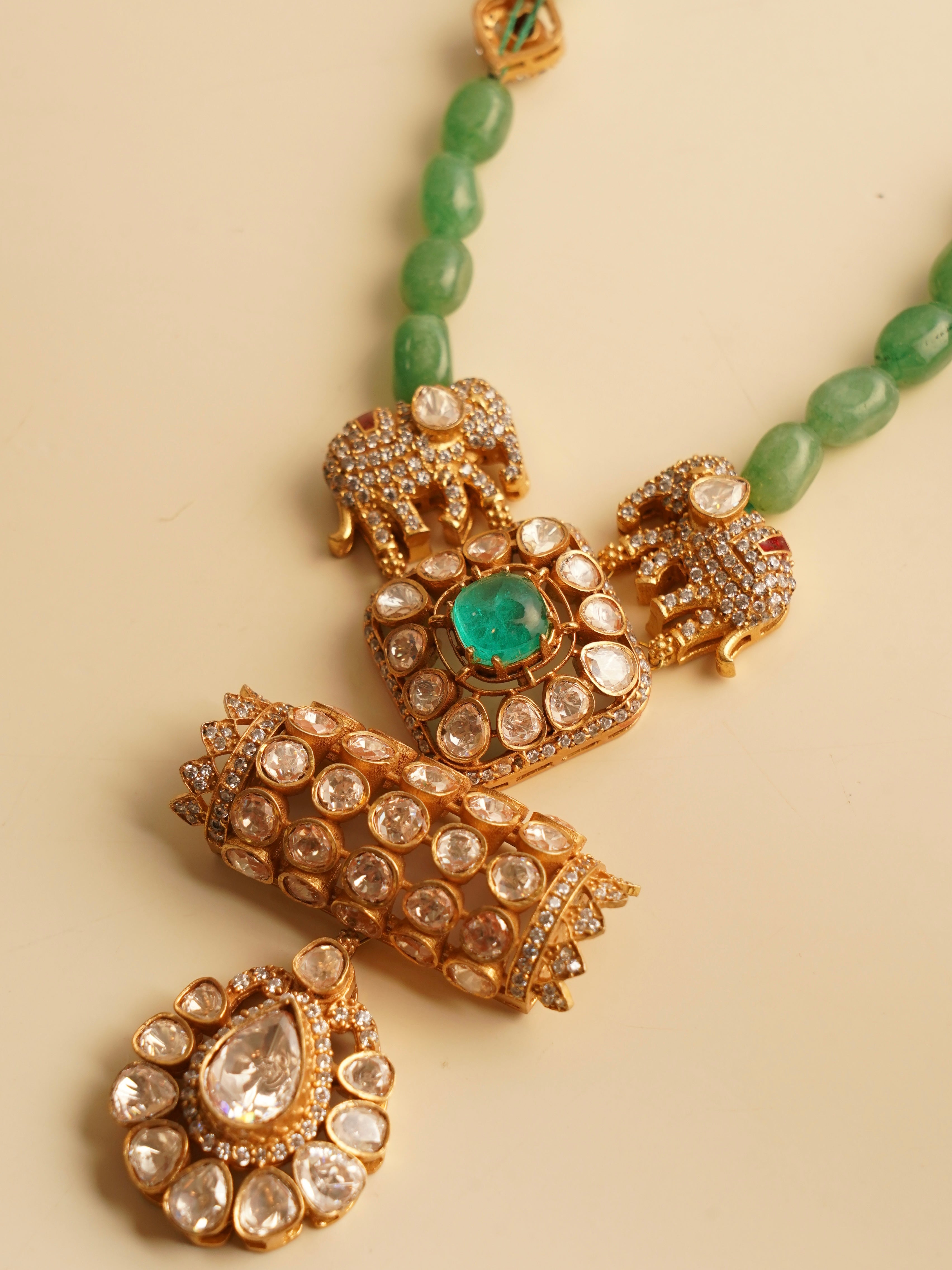 Back view of elephant necklace showing detailed enamel and pearl hangings