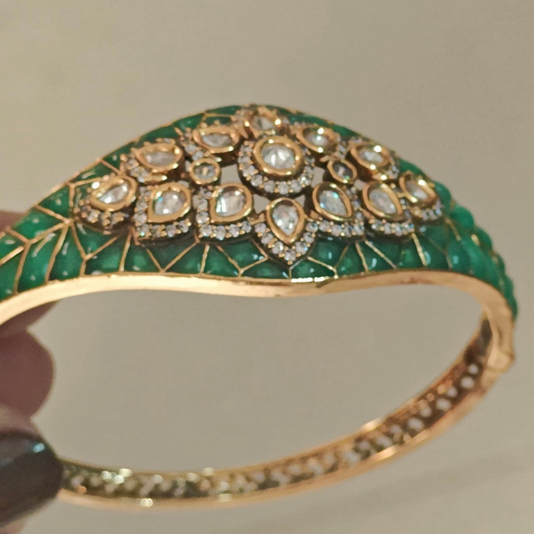 Top view of enamel-finished gold bracelet with dazzling Kundan stone detailing