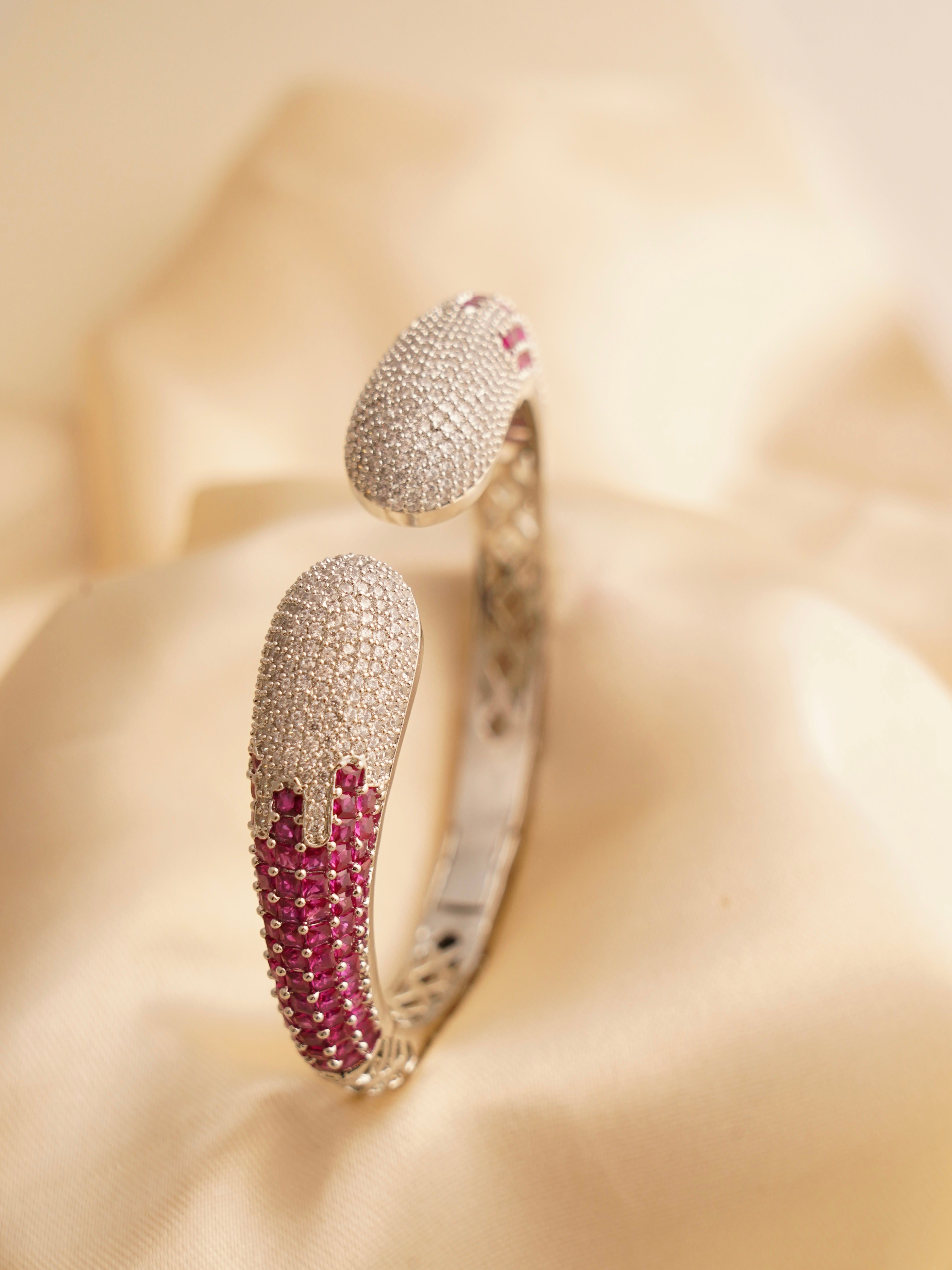 Angled close-up of zircon-studded bracelet with polished gold finish