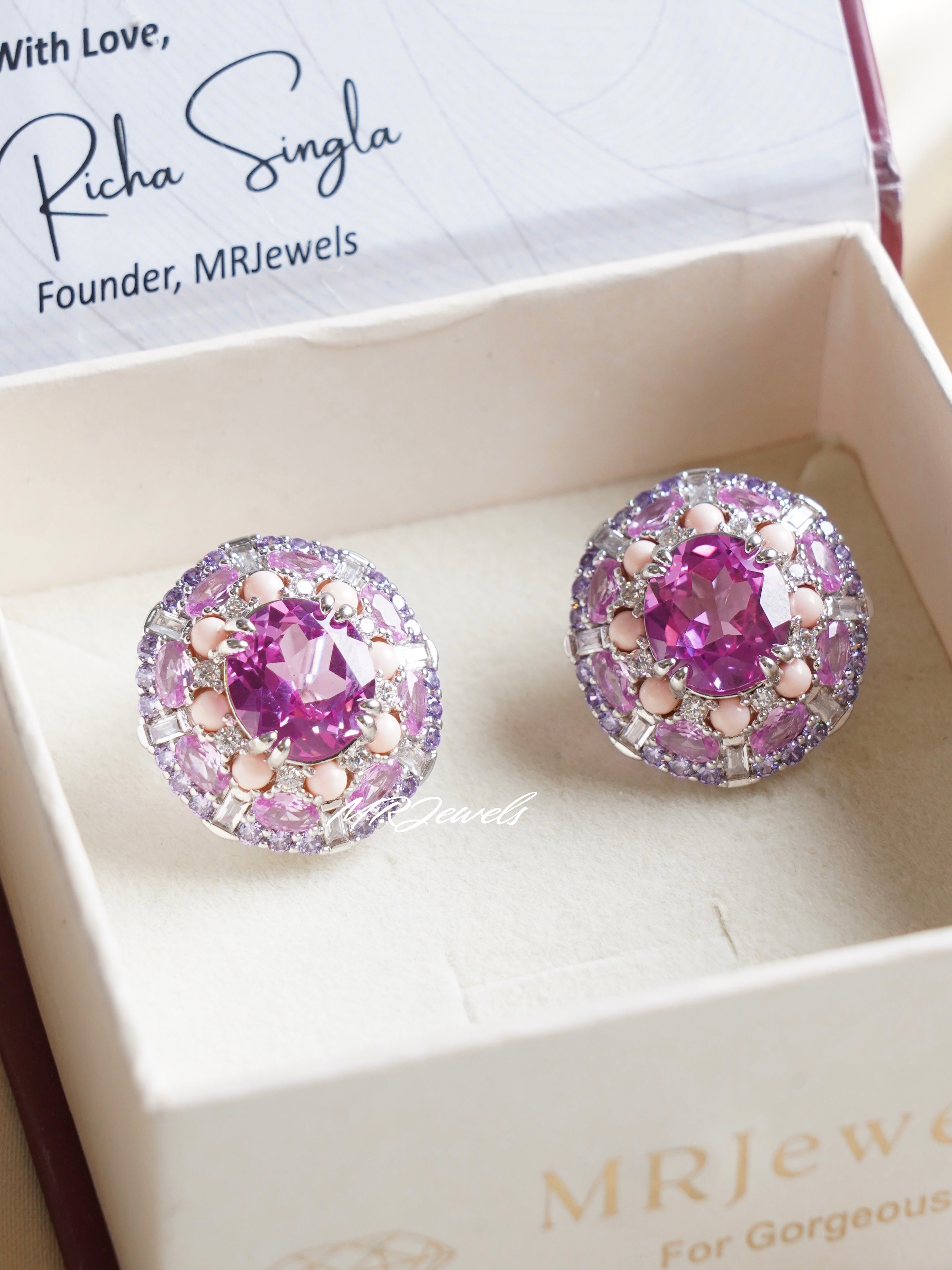 Close-up of crystal stud earrings with smooth round cut and polished silver-toned surface