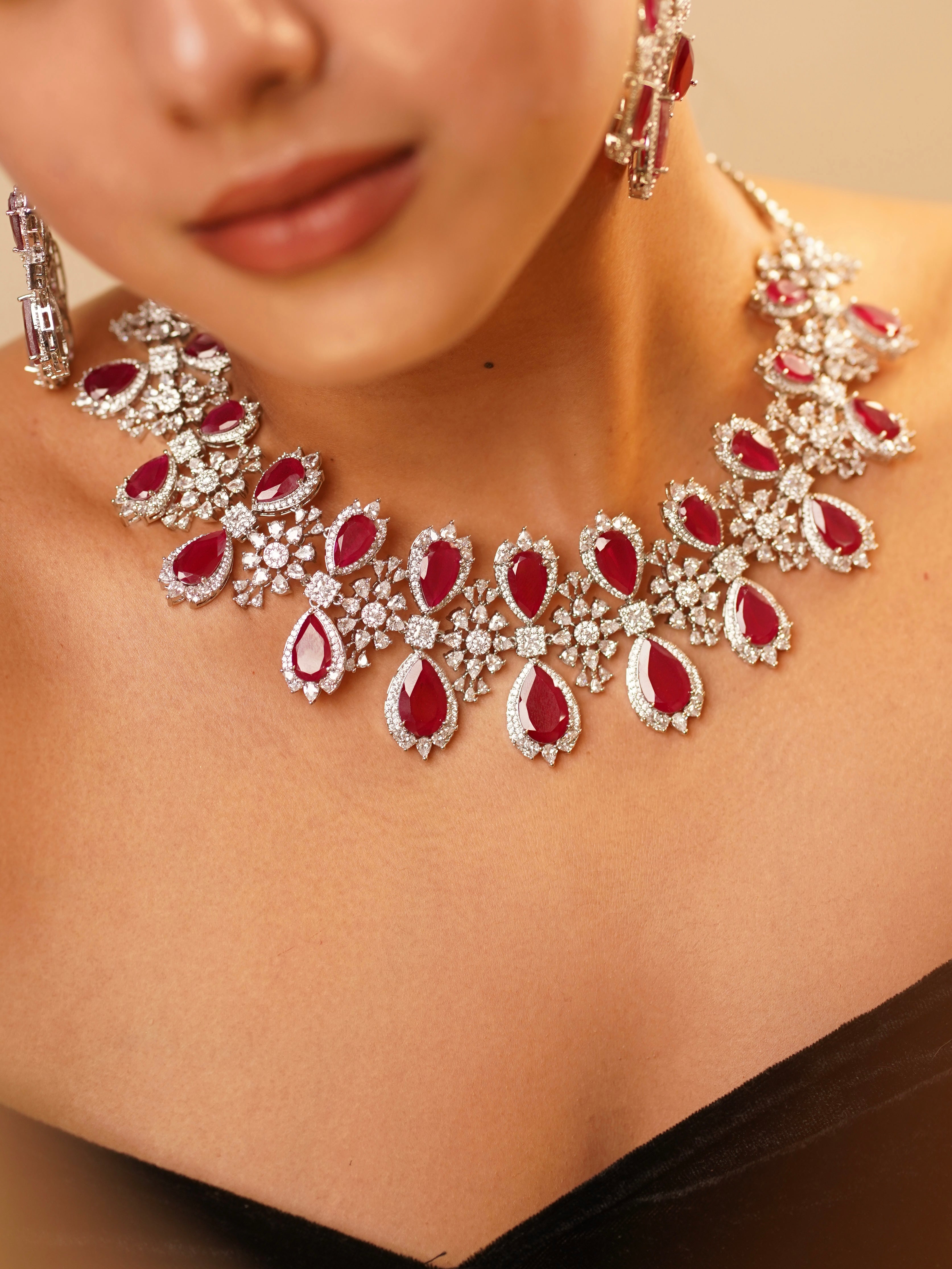 Urvi necklace set with bold red central stone and floral kundan motifs
