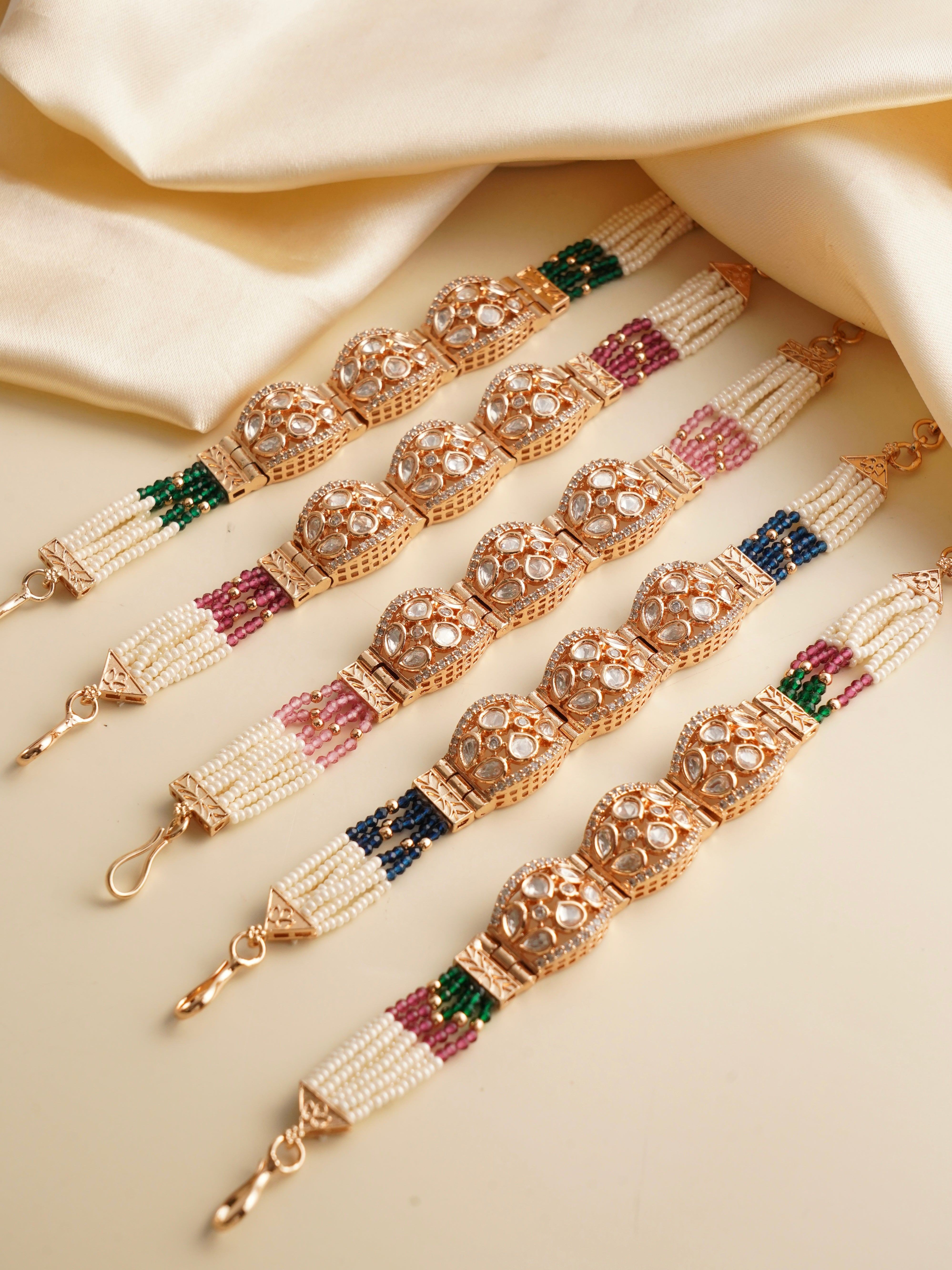 Assortment of polki dome bracelets with uncut stones, pearl strands and colored beads
