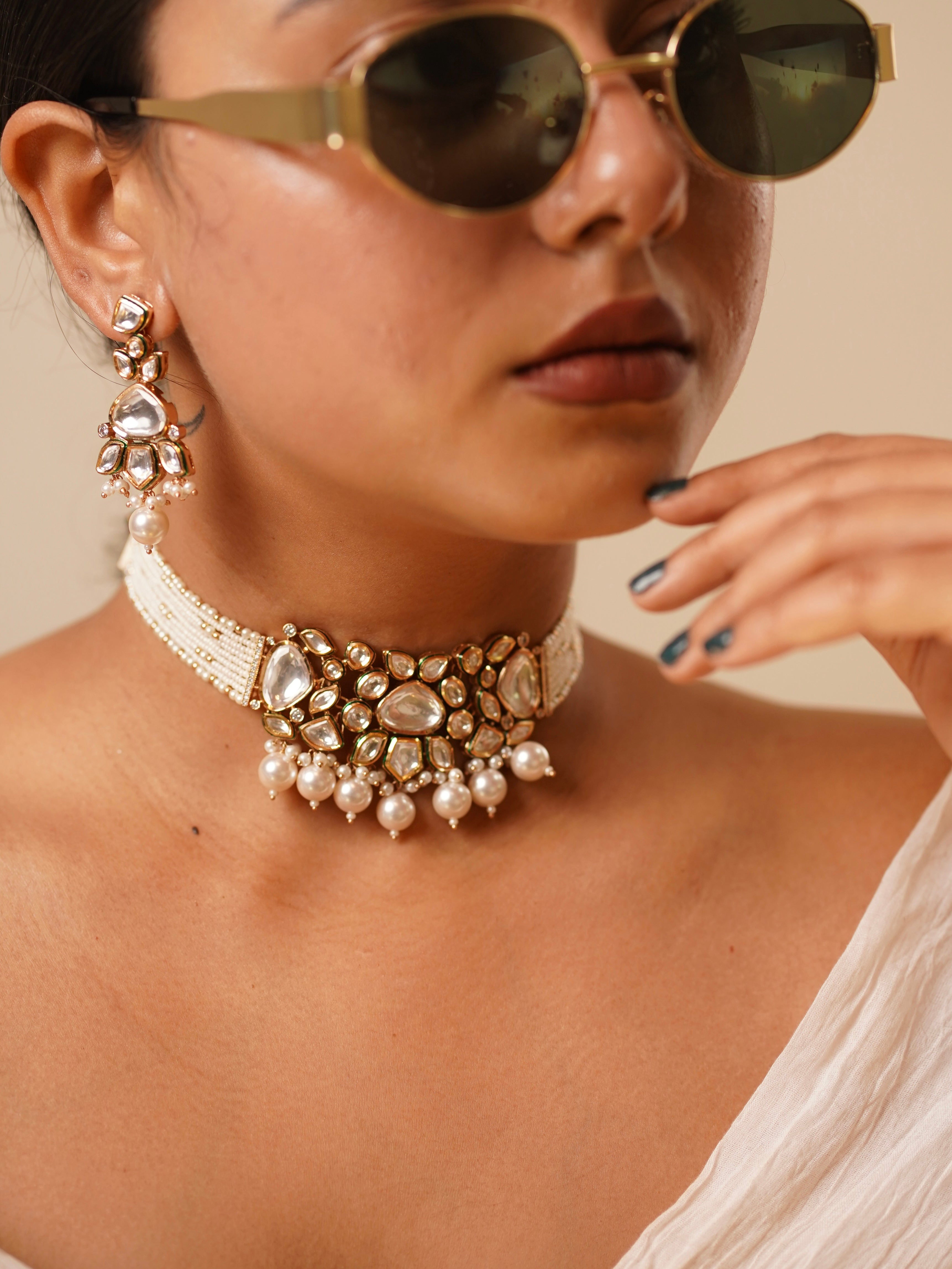 Side view of kundan pearl choker necklace showcasing pearl clusters and engraved elements