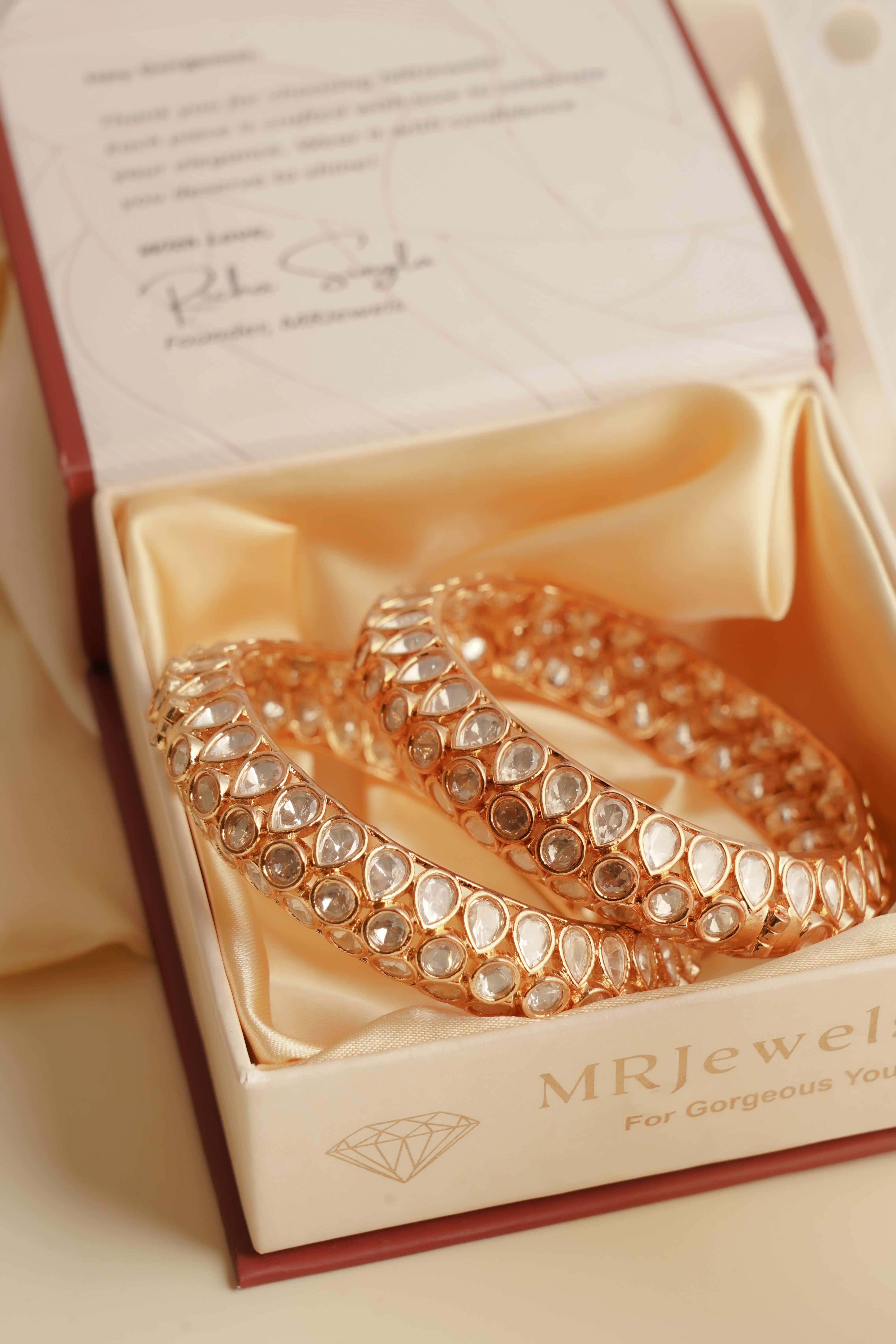 Side view of cluster polki bangles showcasing raised uncut stones and copper base