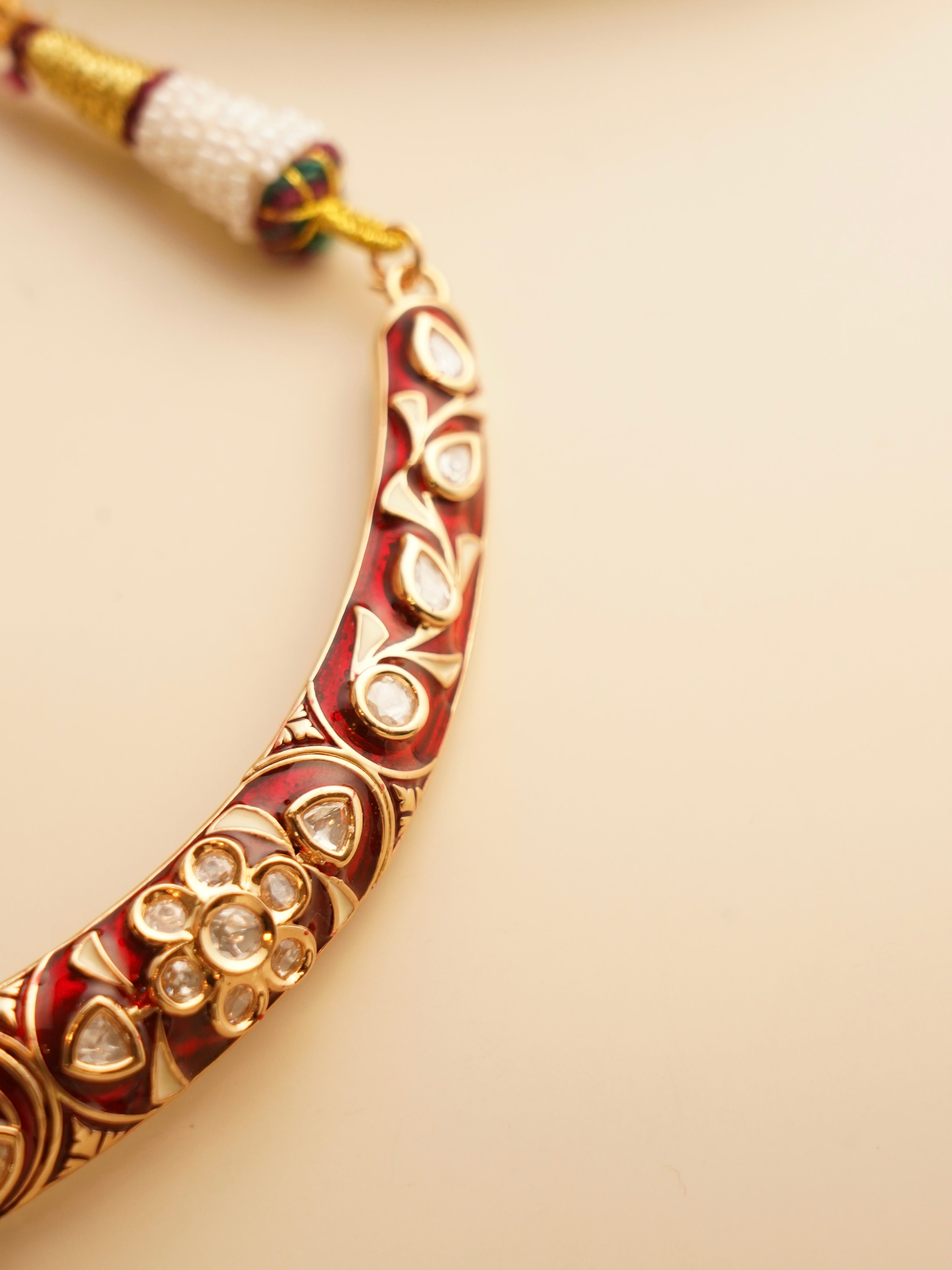 Close-up of meenakari hasli featuring vibrant colors and bold ethnic design
