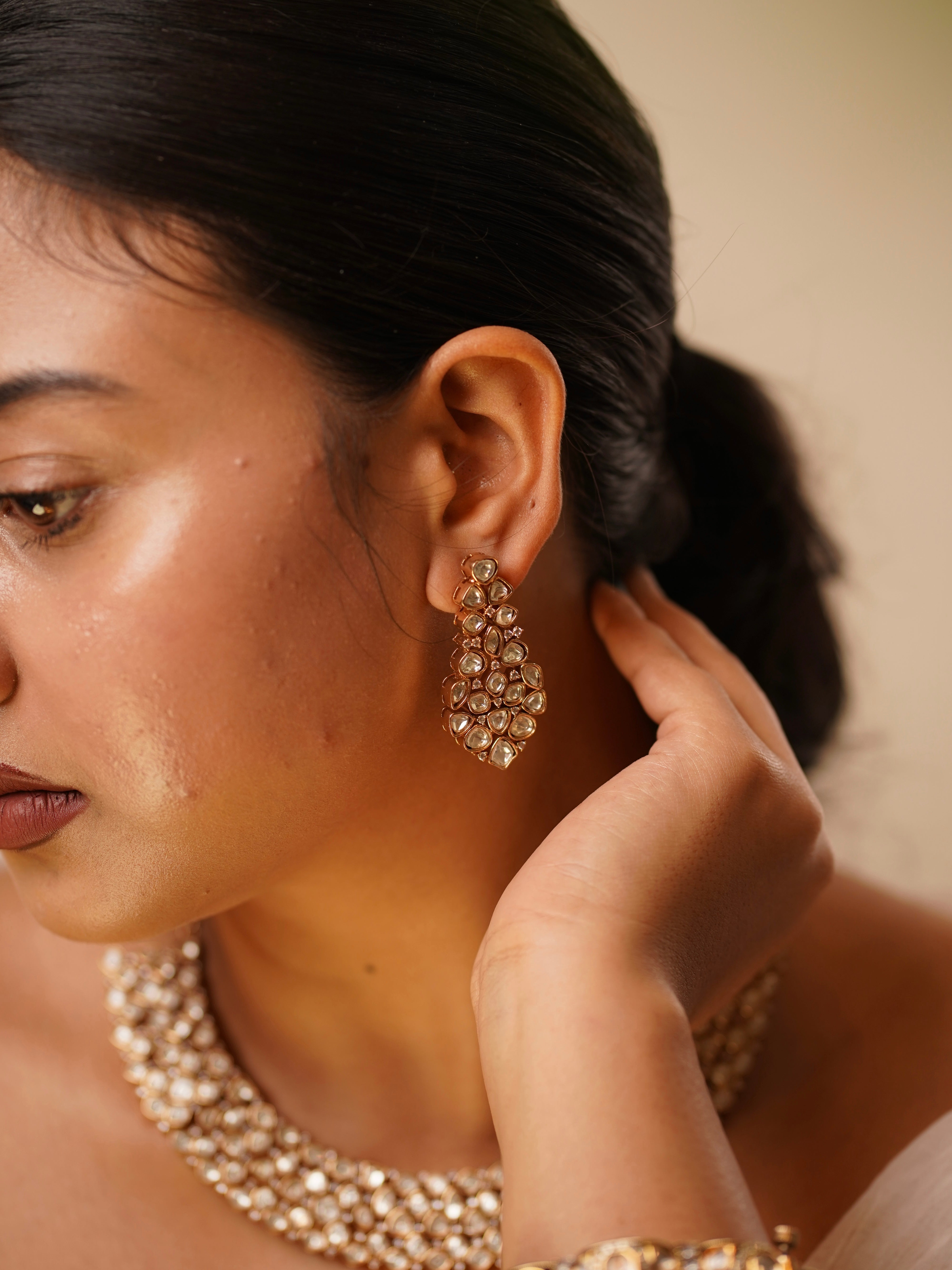 Close-up of kundan earrings and necklace showcasing symmetrical celestial design