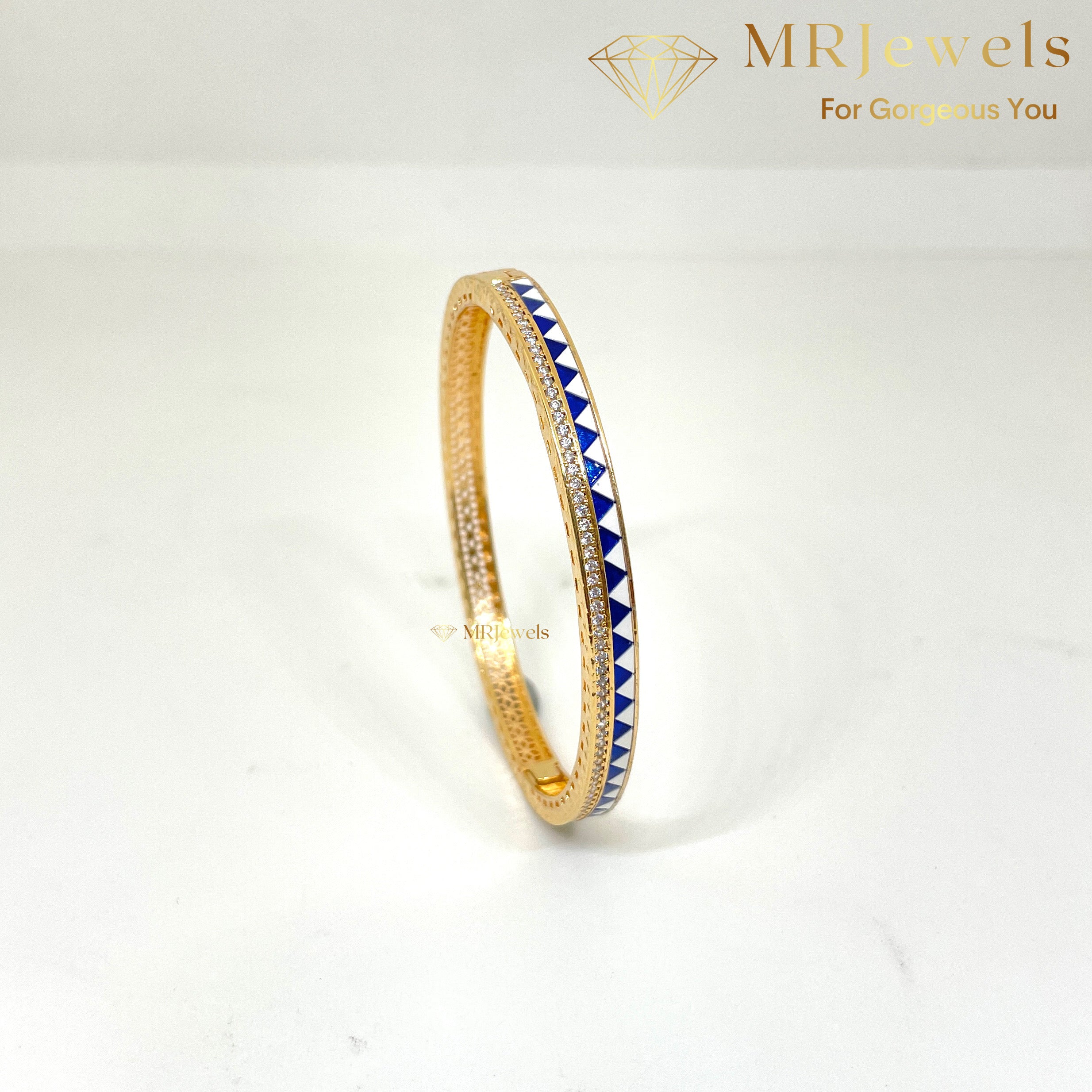 Angled shot of enamel diamond bracelet showing textured band and polished metalwork