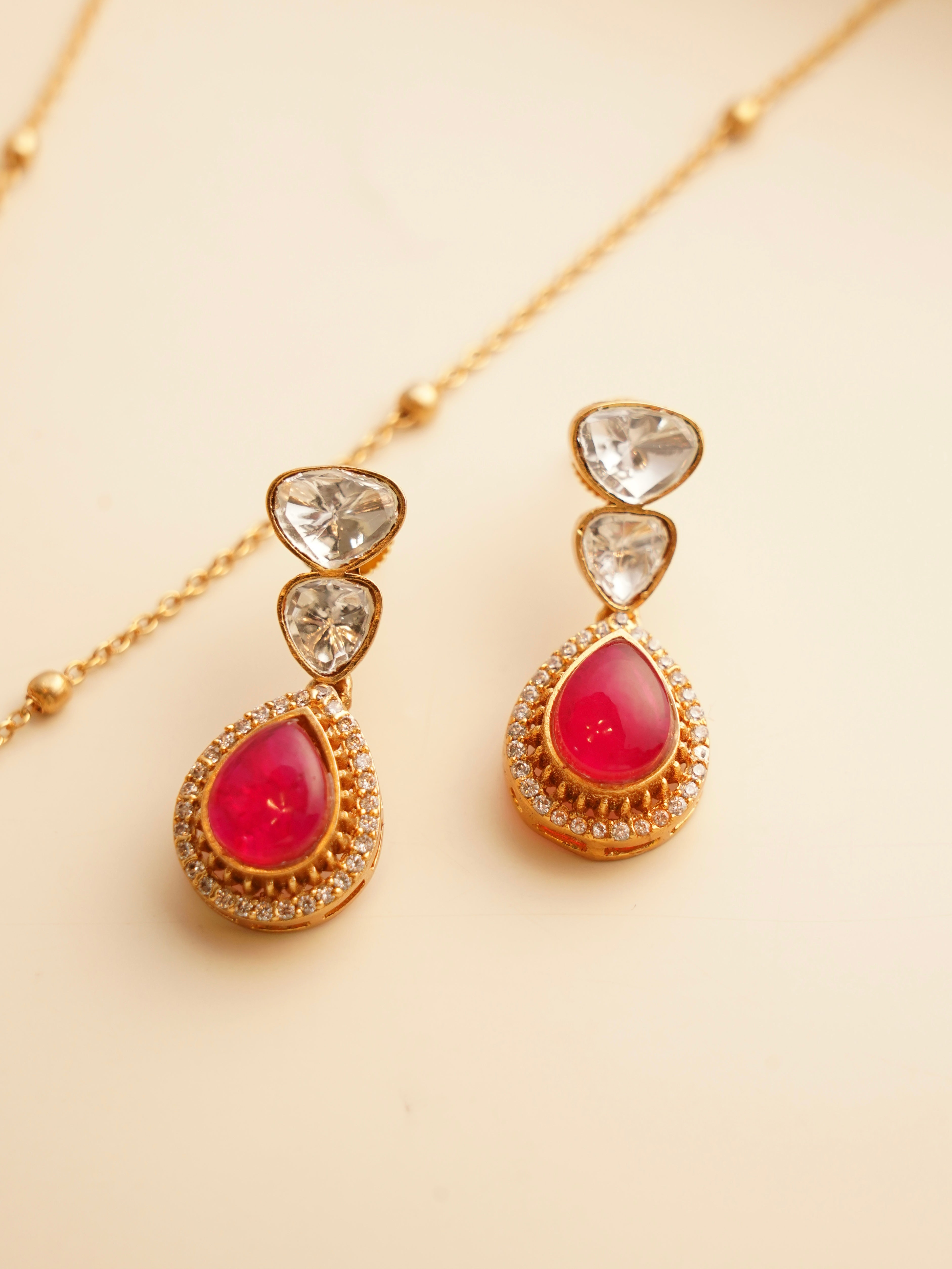 Ruby centre teardrop necklace with kundan-inspired circular pendant and gold finish
