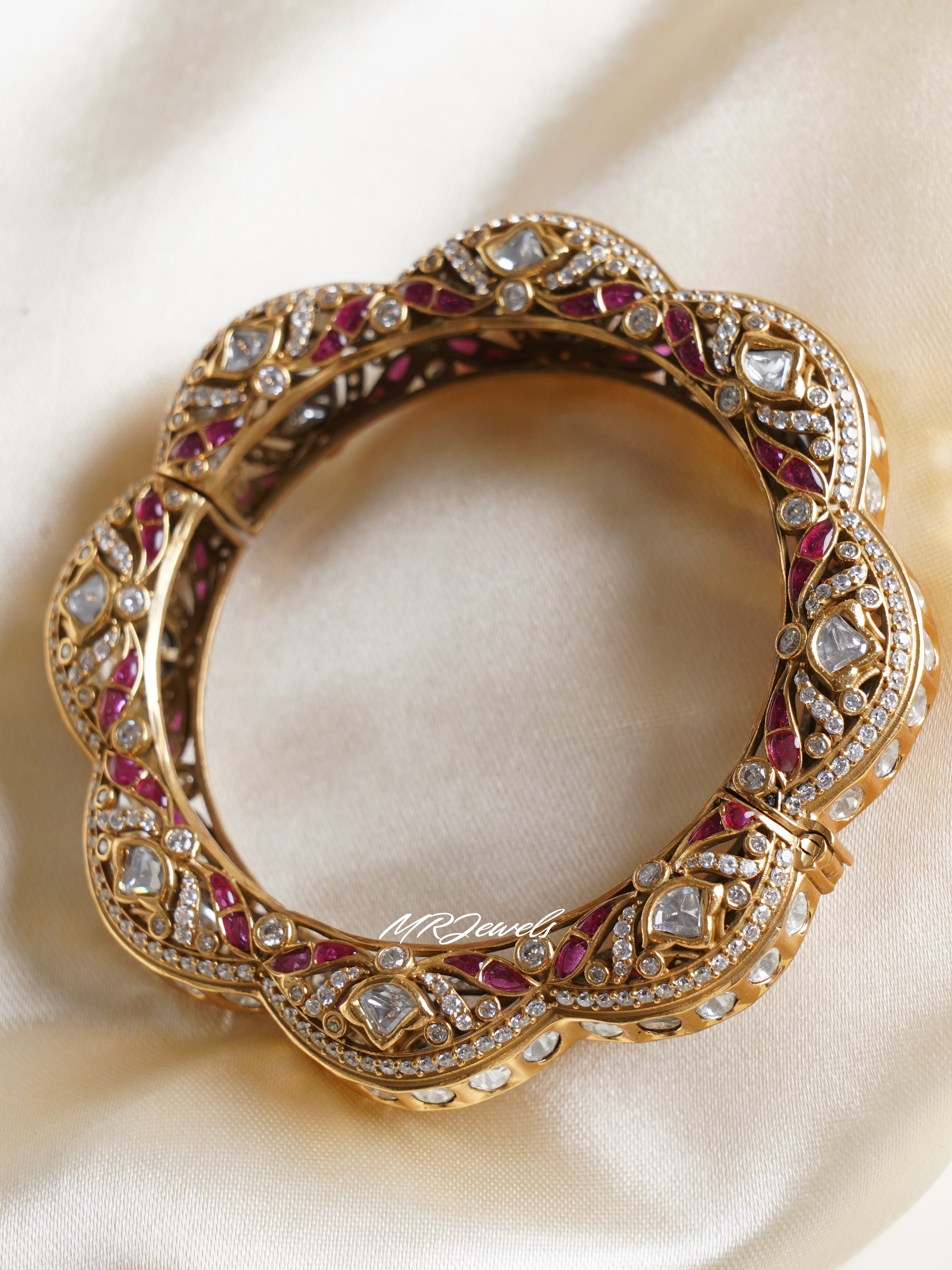 Angled view of kundan kadas with gold polish and detailed craftsmanship