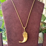 Detailed shot of spiritual trident pendant with polished finish and stone accent