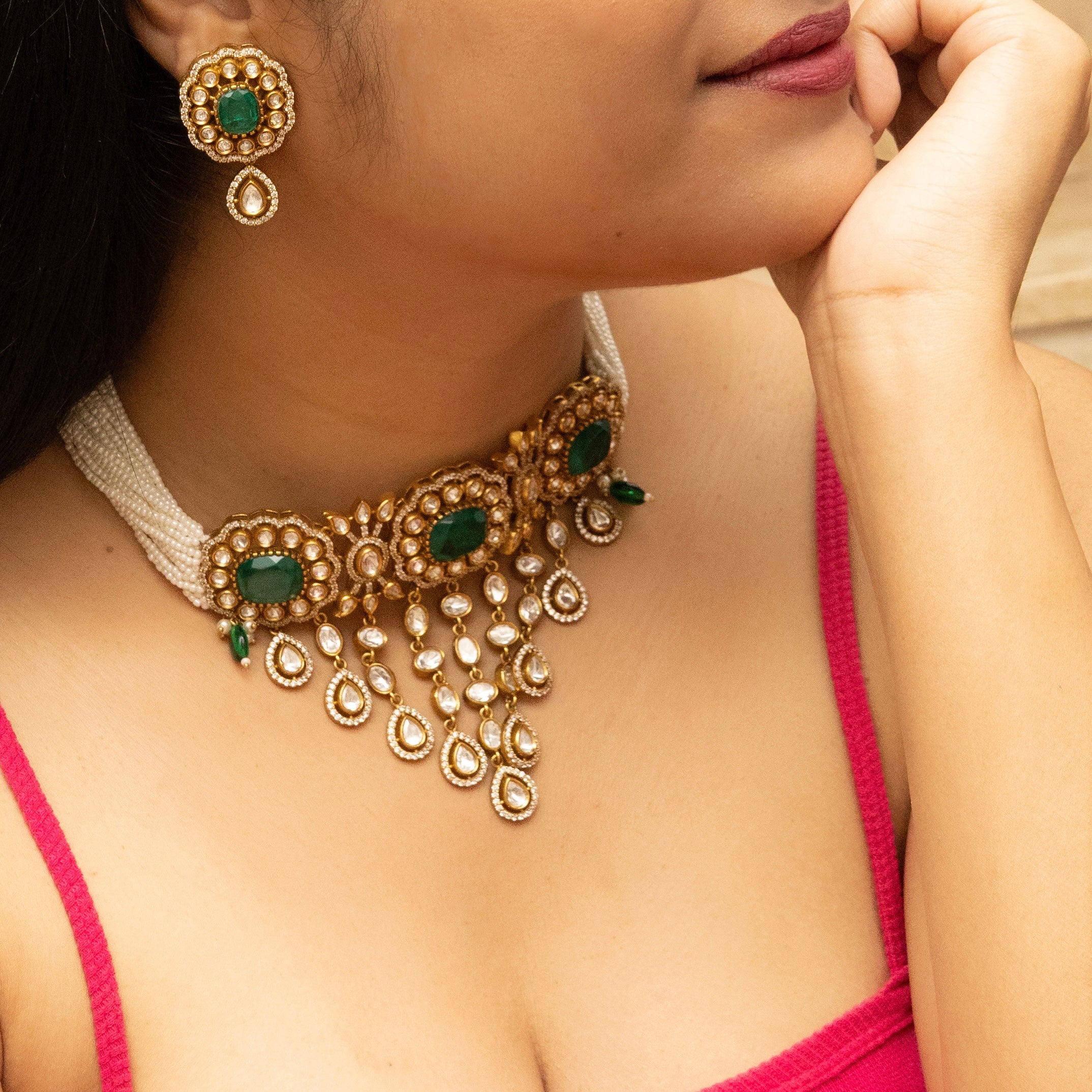 Green choker necklace with beadwork and gold-toned detailing in traditional style