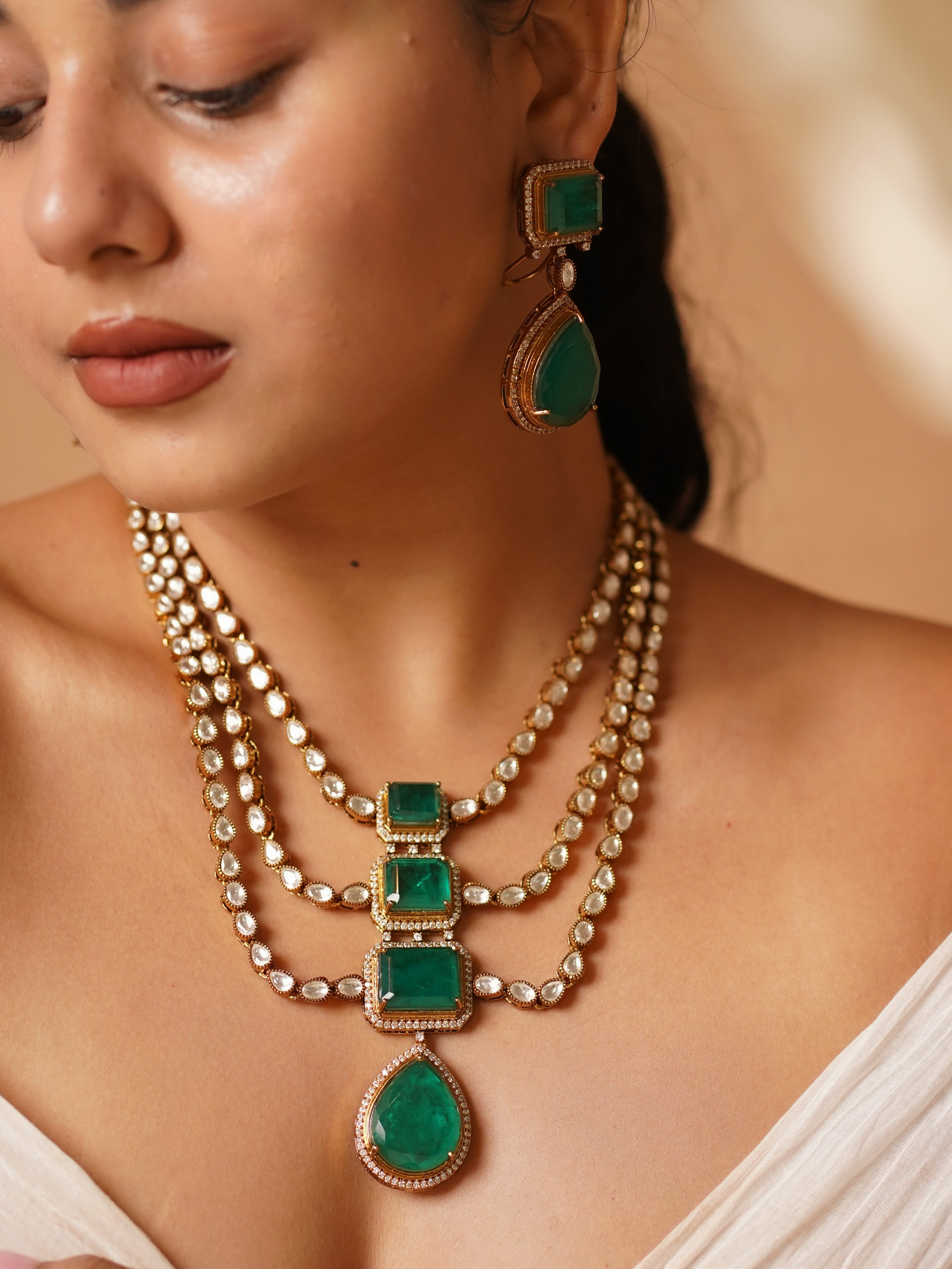 Victorian necklace set with emerald green stones and pearl-encrusted layers