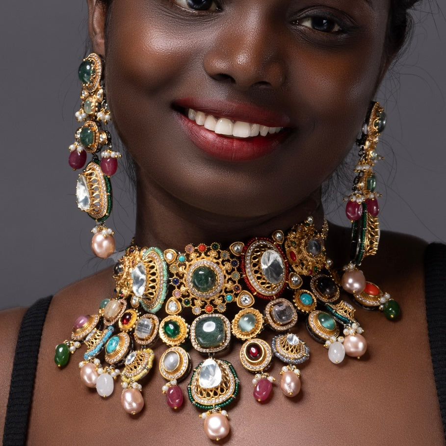 Front view of lavish gem choker featuring ruby, emerald, and moonstone settings