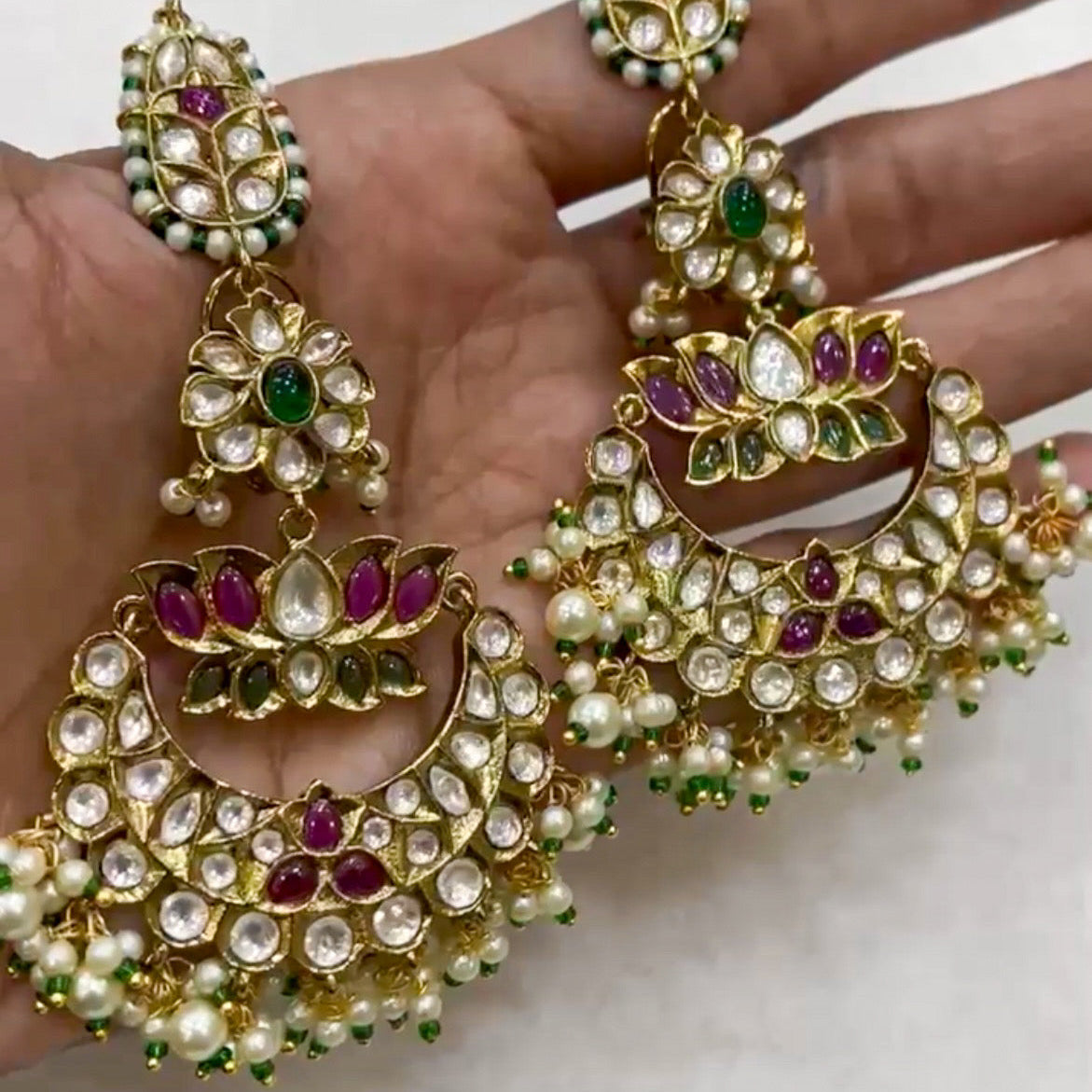 Side angle of polki chandbalis with pearl danglers and vibrant stone embellishments