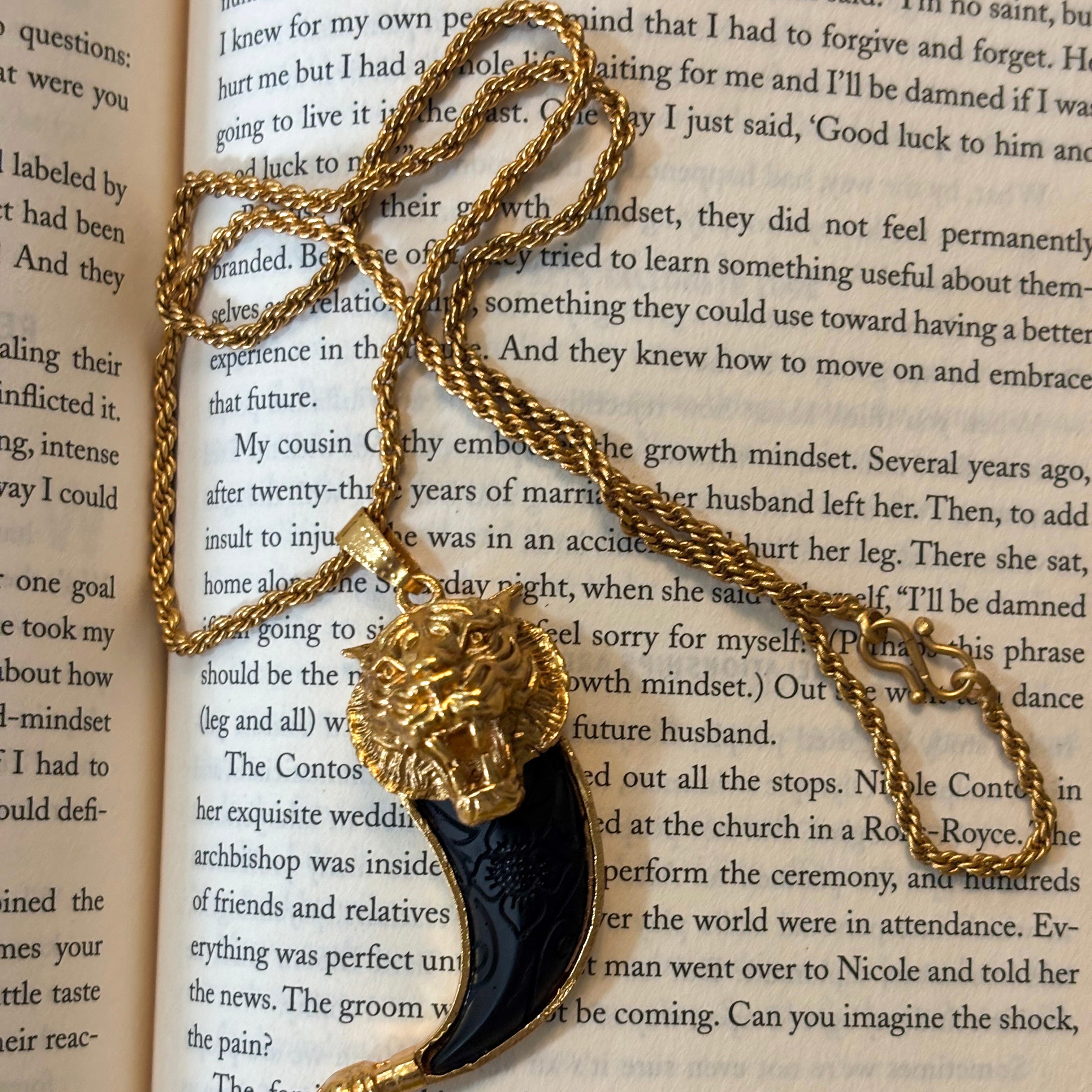 Tiger tooth pendant in gold-toned copper alloy with sleek nail-inspired shape