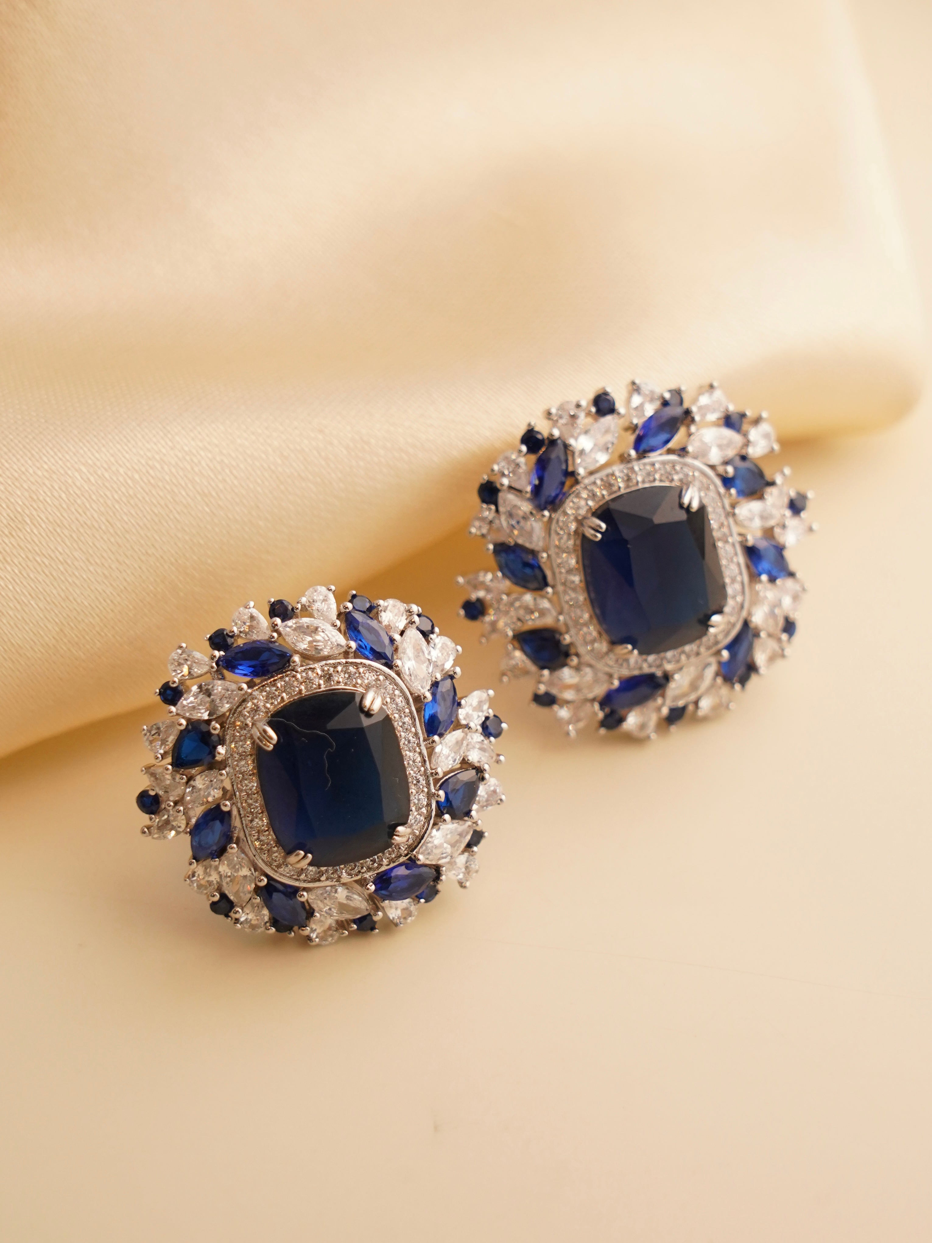 Top view of yellow Swarovski studs with brilliant halo and smooth polished metal finish