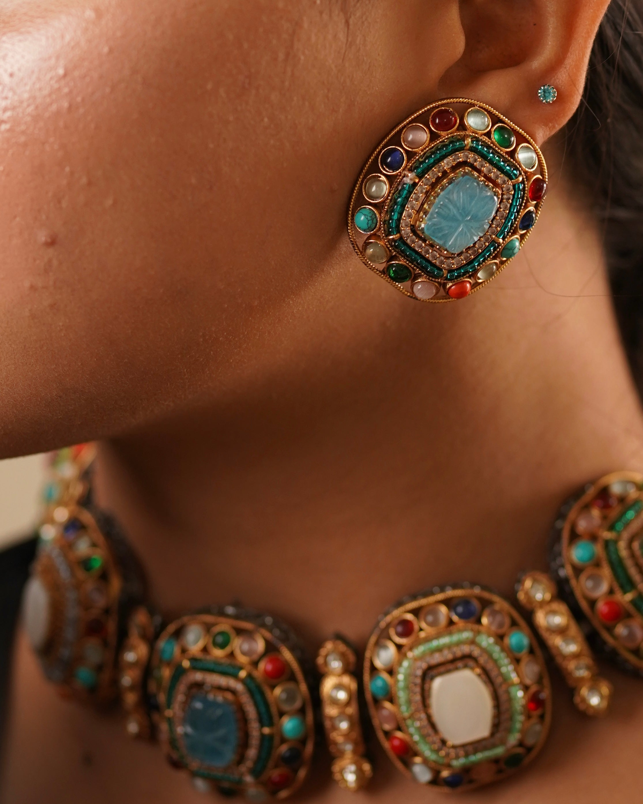 Close-up of matching earrings from sabya-style set with textured finish and dangling elements