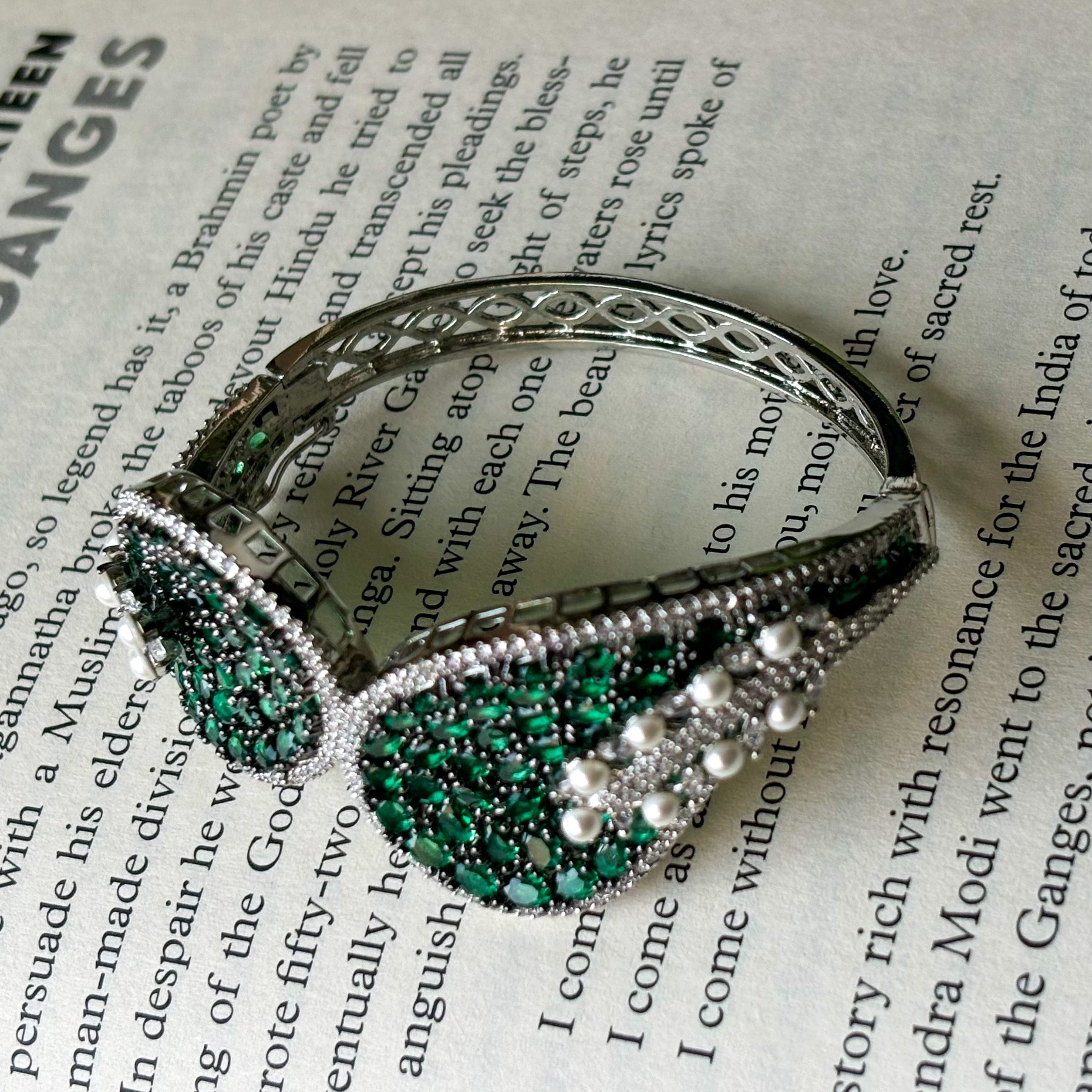Angled shot of openable bracelet showing clasp and embedded diamond-style stones