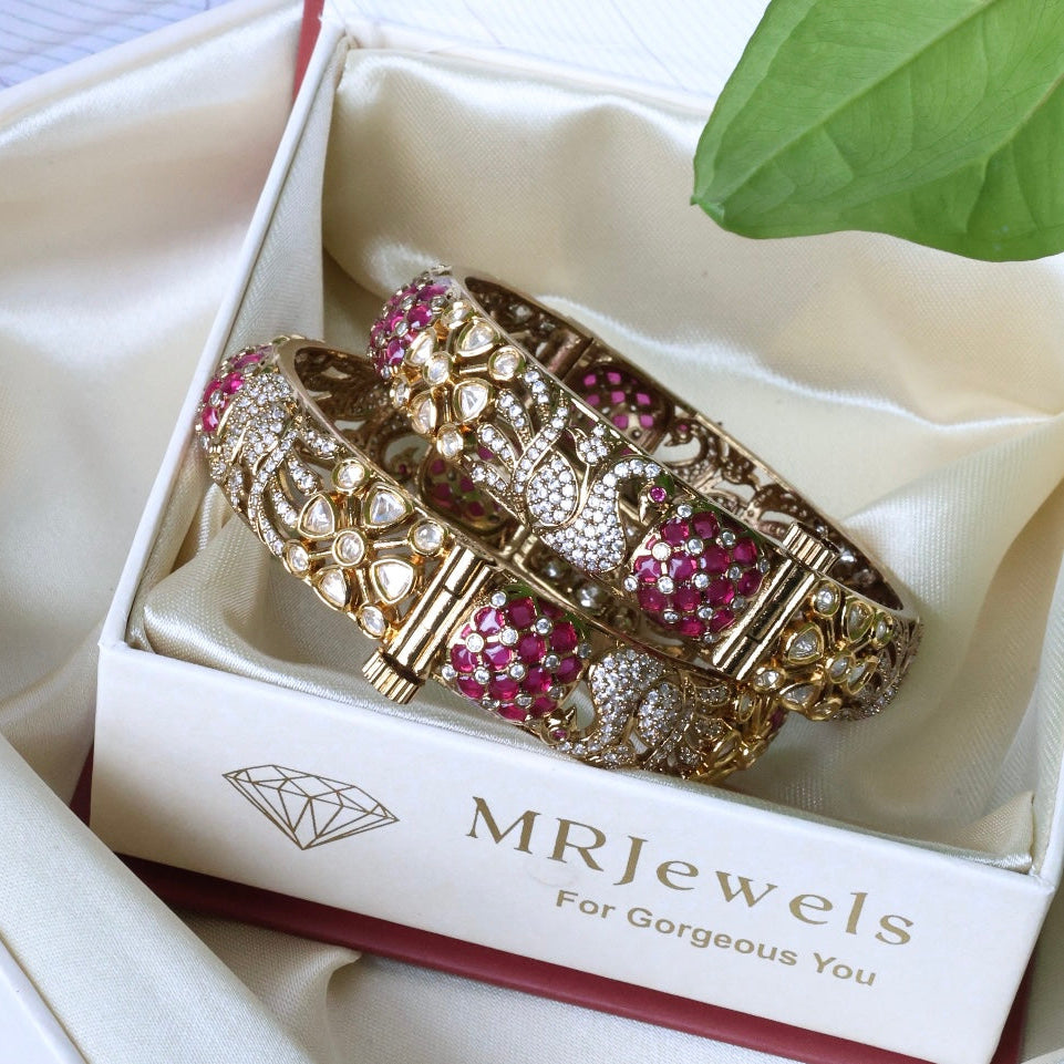 Front view of Zehra kundan bangles with ruby and emerald stones in openable pair design
