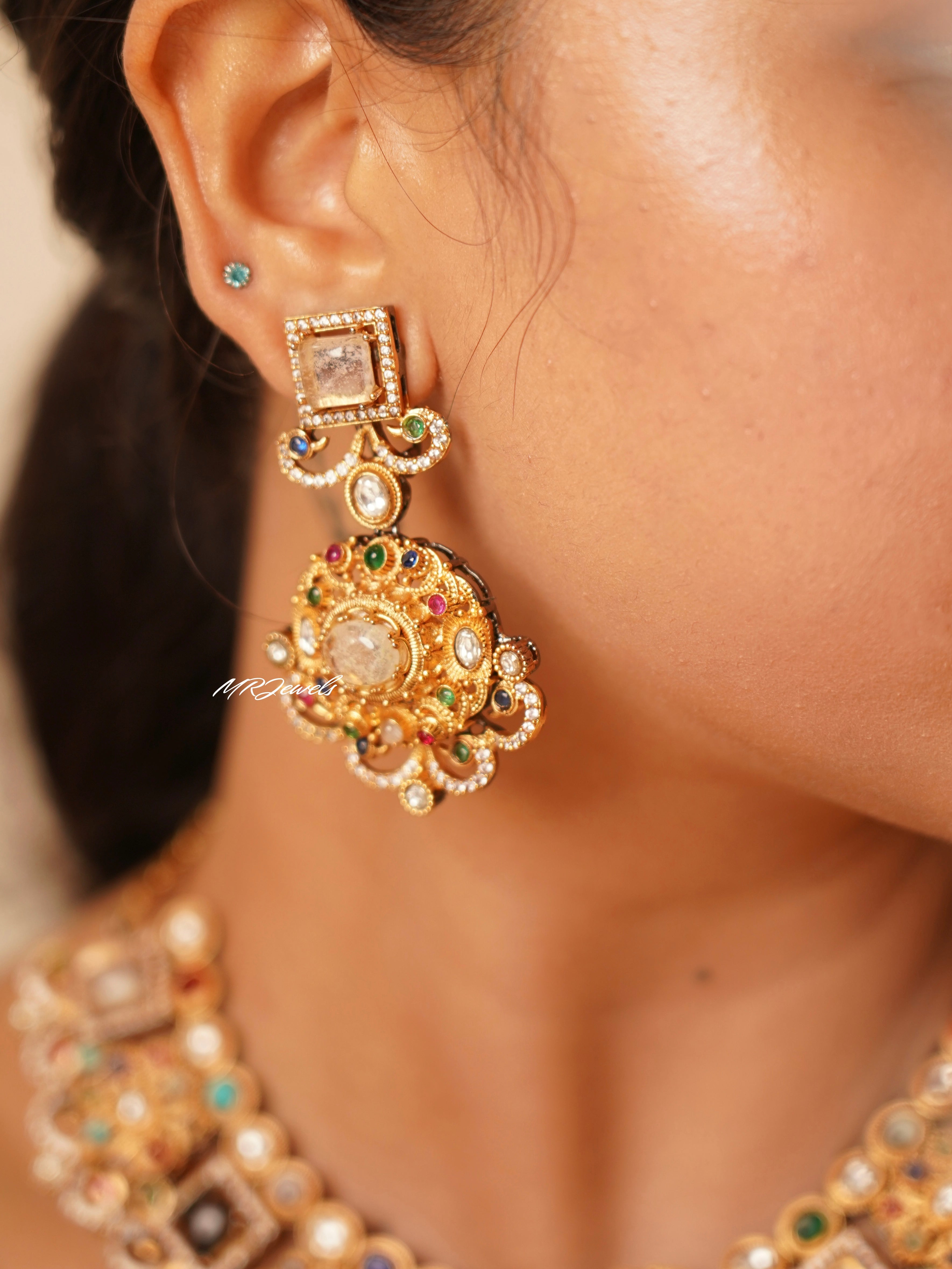 Matching earrings from grandeur artisan set with gold-tone motifs and pearl accents