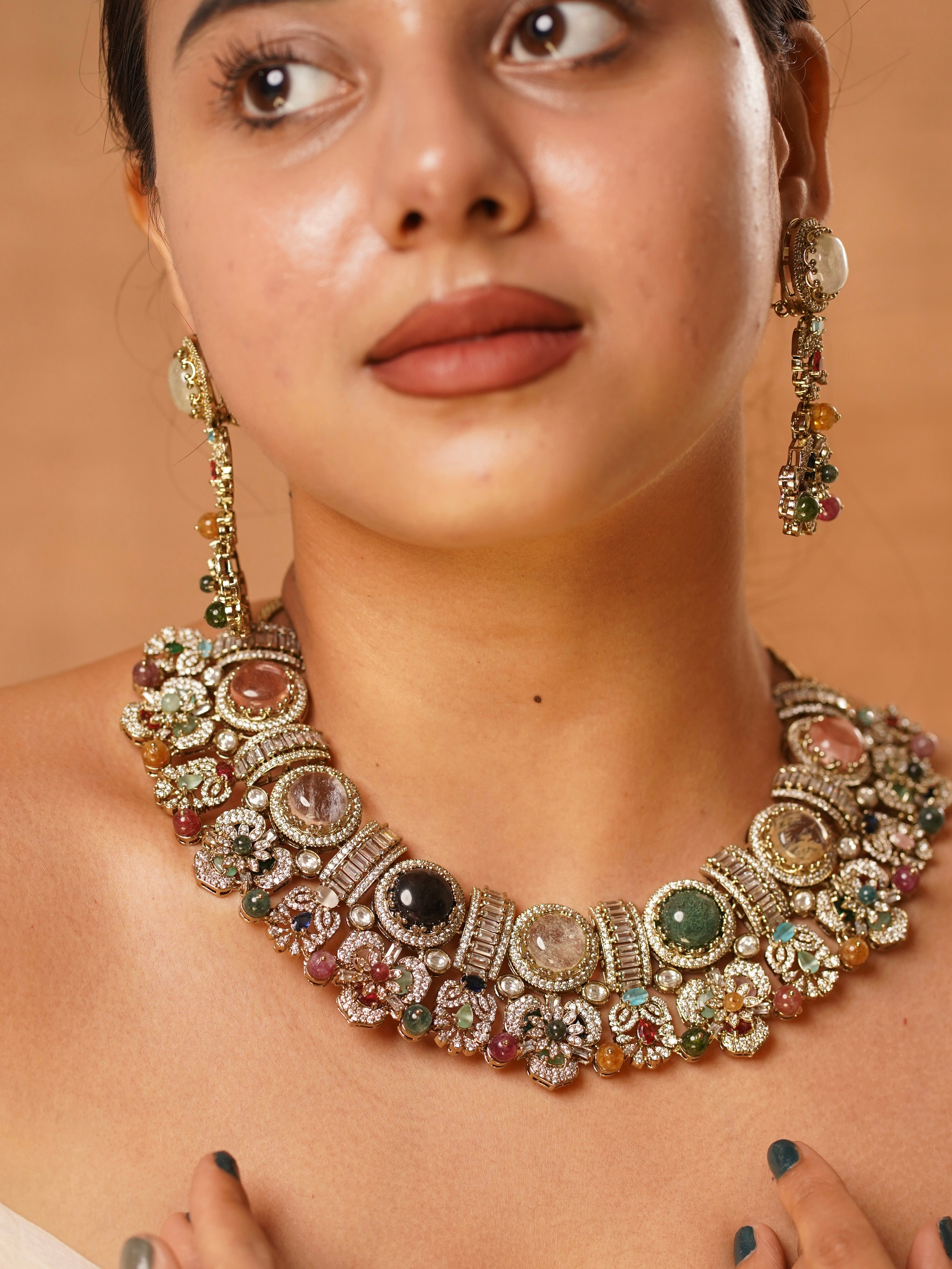 Side view of heritage multigem necklace and earring set with rich polki and kundan accents