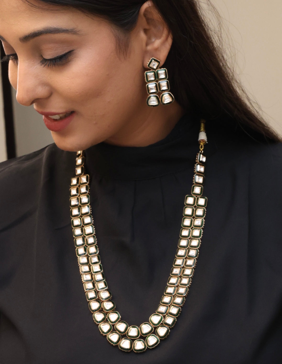 Close-up of necklace earrings with CZ stones and intricate setting work