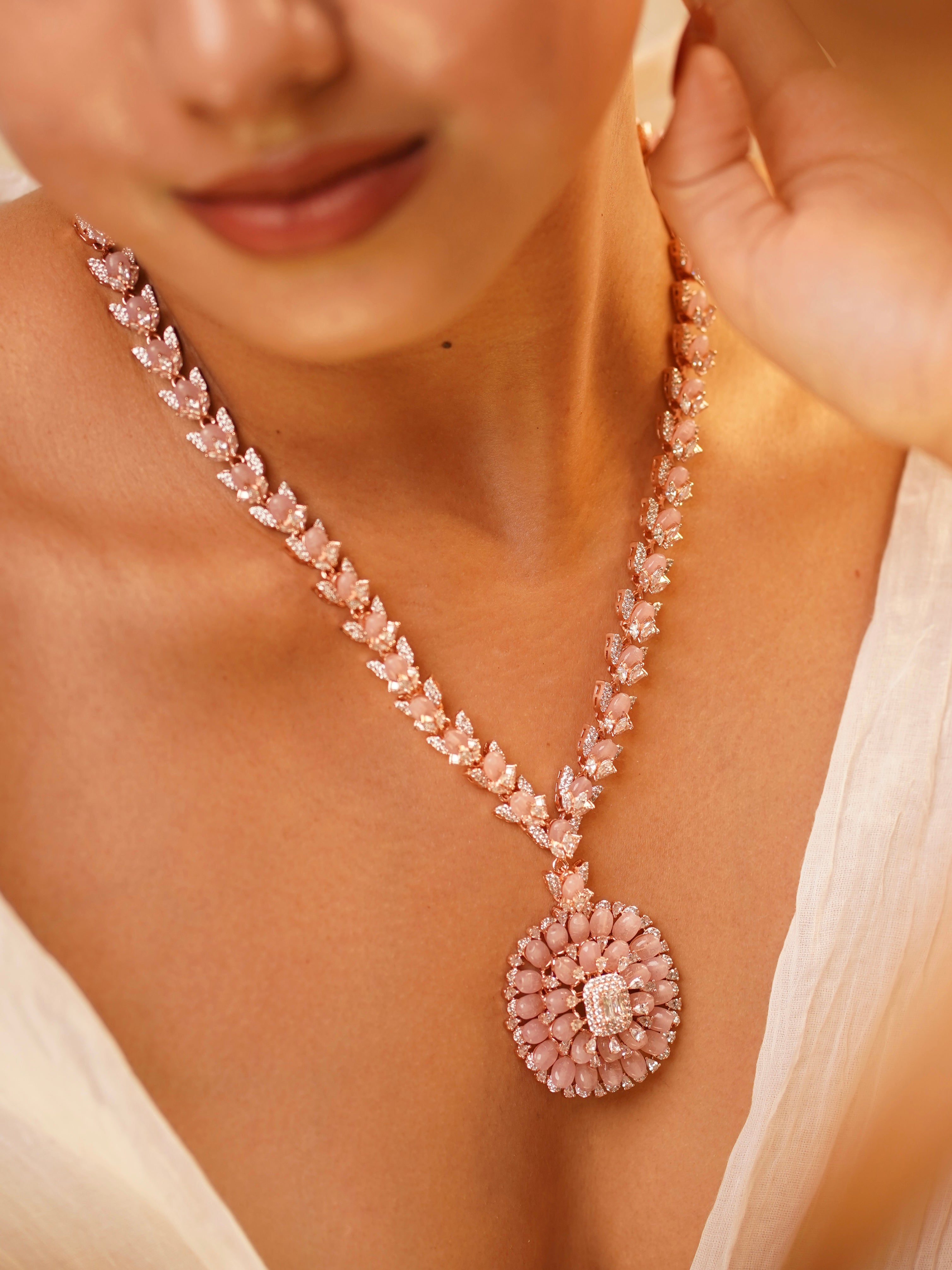 long rose gold beaded necklace paired with textured studs in copper alloy