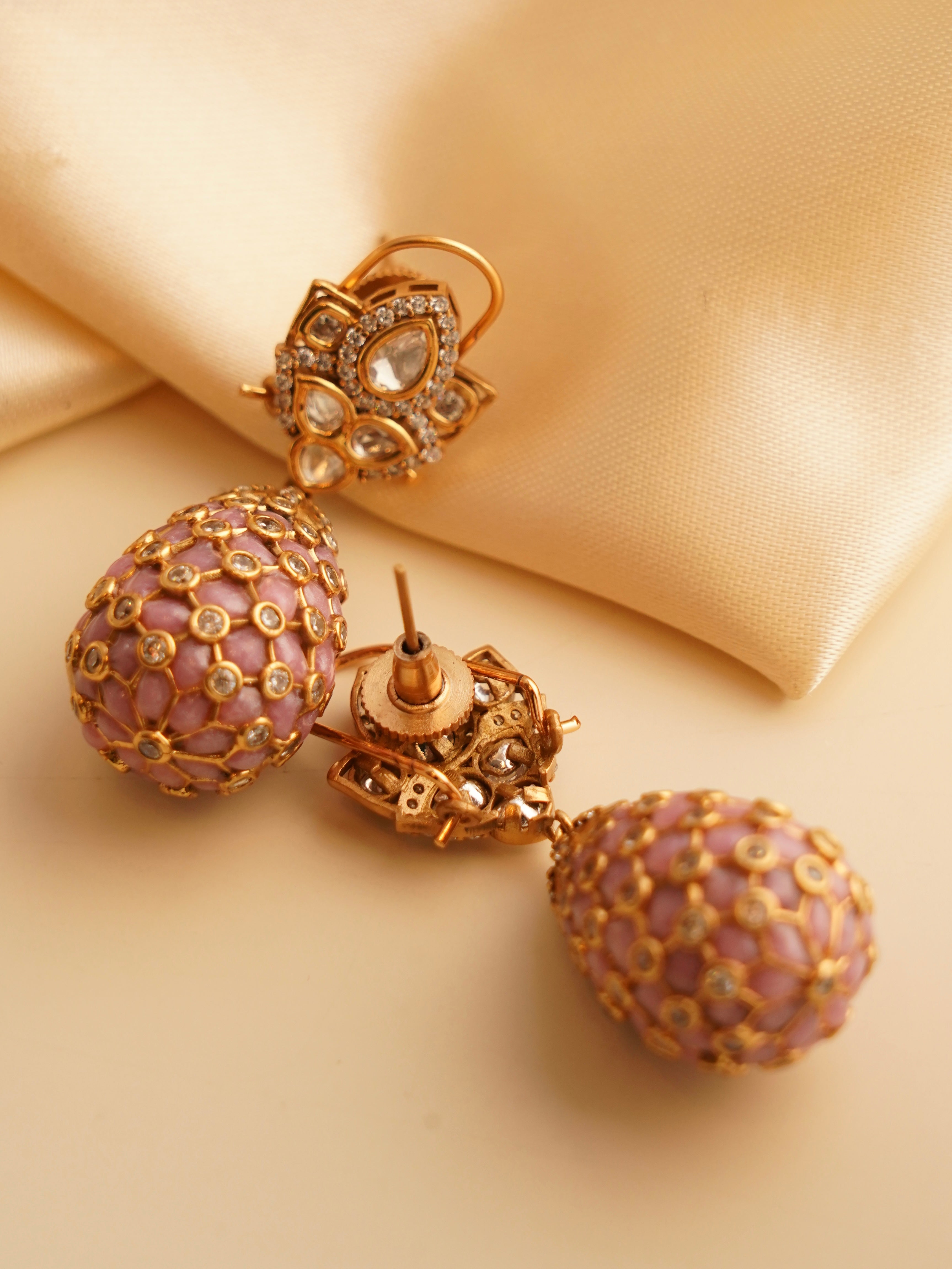 side profile of polki droplet earrings with round and oval stones