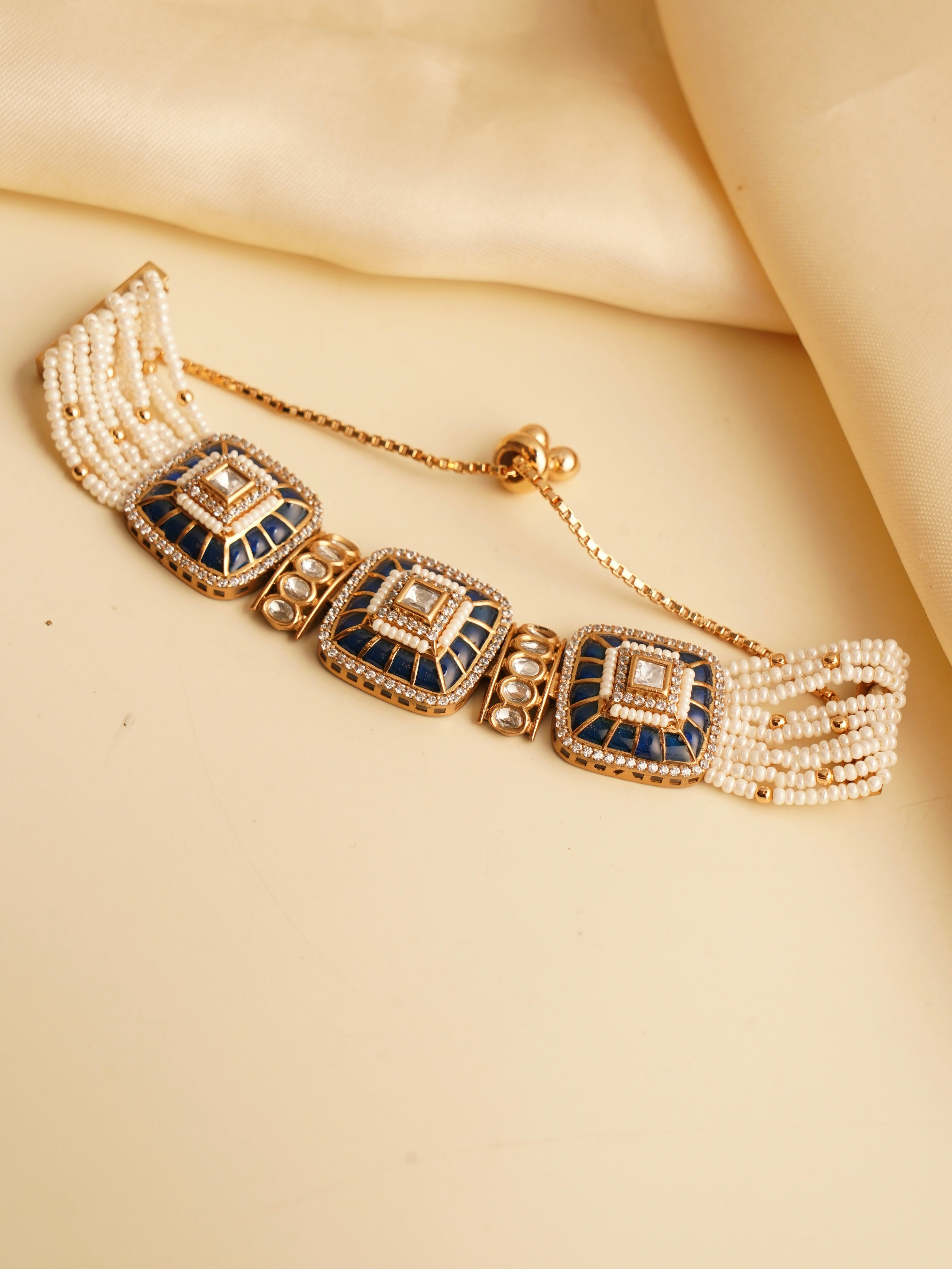 Close-up of Eternal Grace bracelet with square kundan design and pearl accents on gold finish