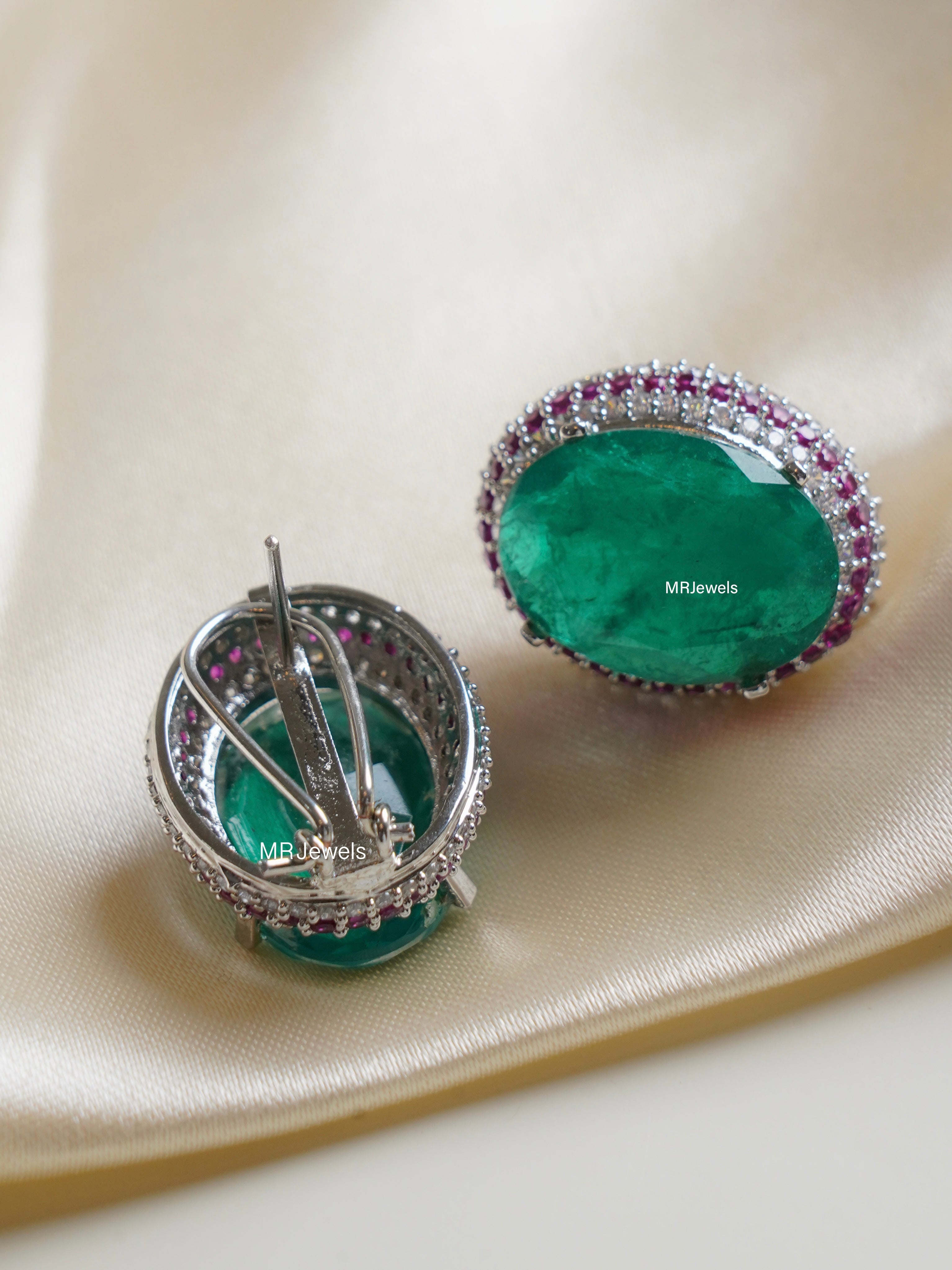 side angle showing clip‑on fastening and layered halo of emerald royale stud earring