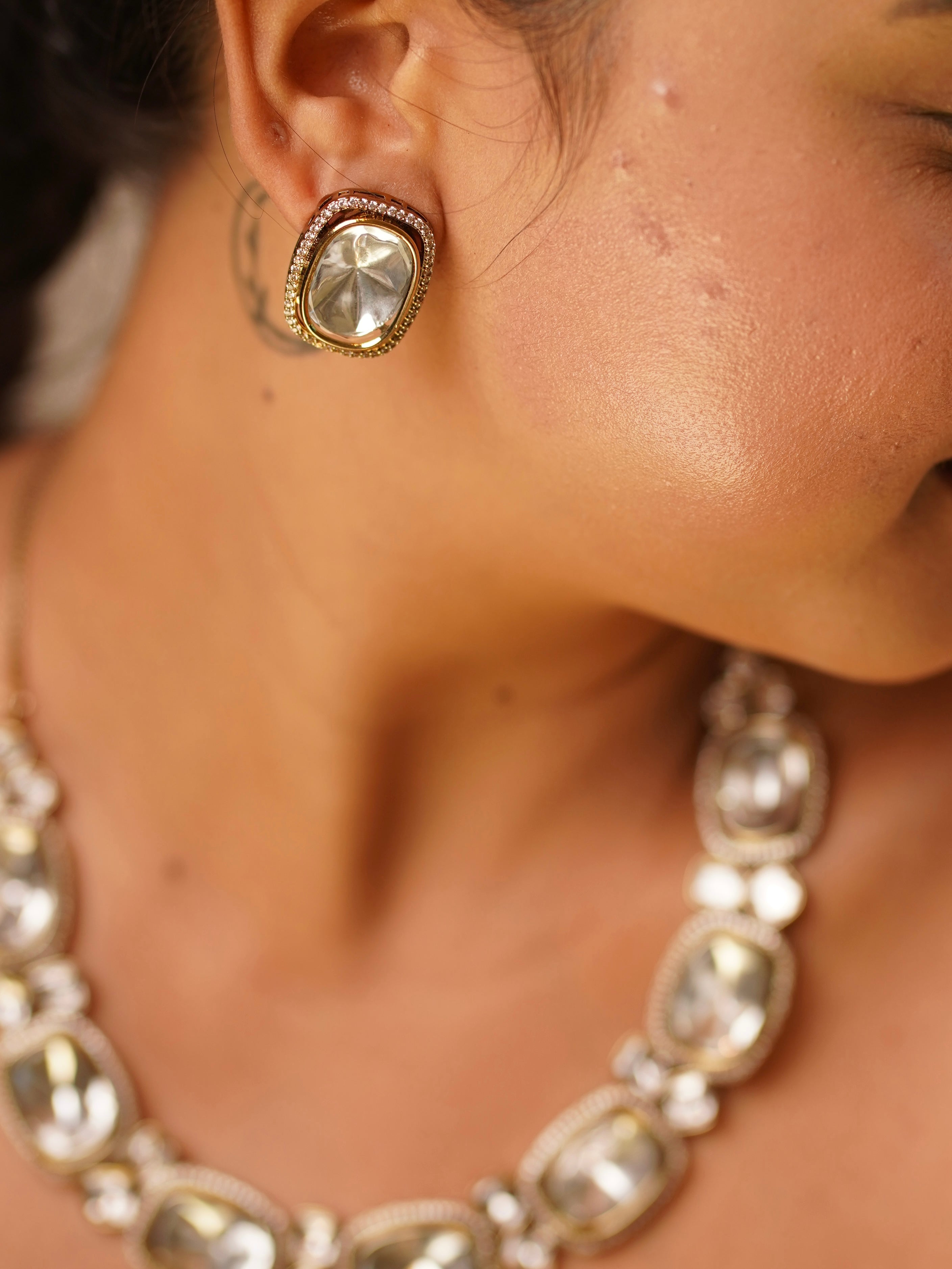 Angled image of heritage-style kundan necklace set with bold central design