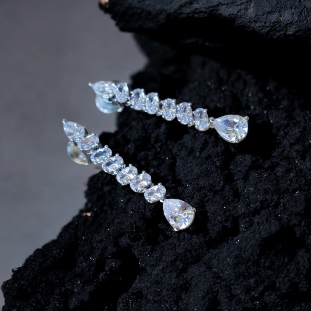 Close-up of teardrop diamond pendant with asymmetrical setting and modern finish