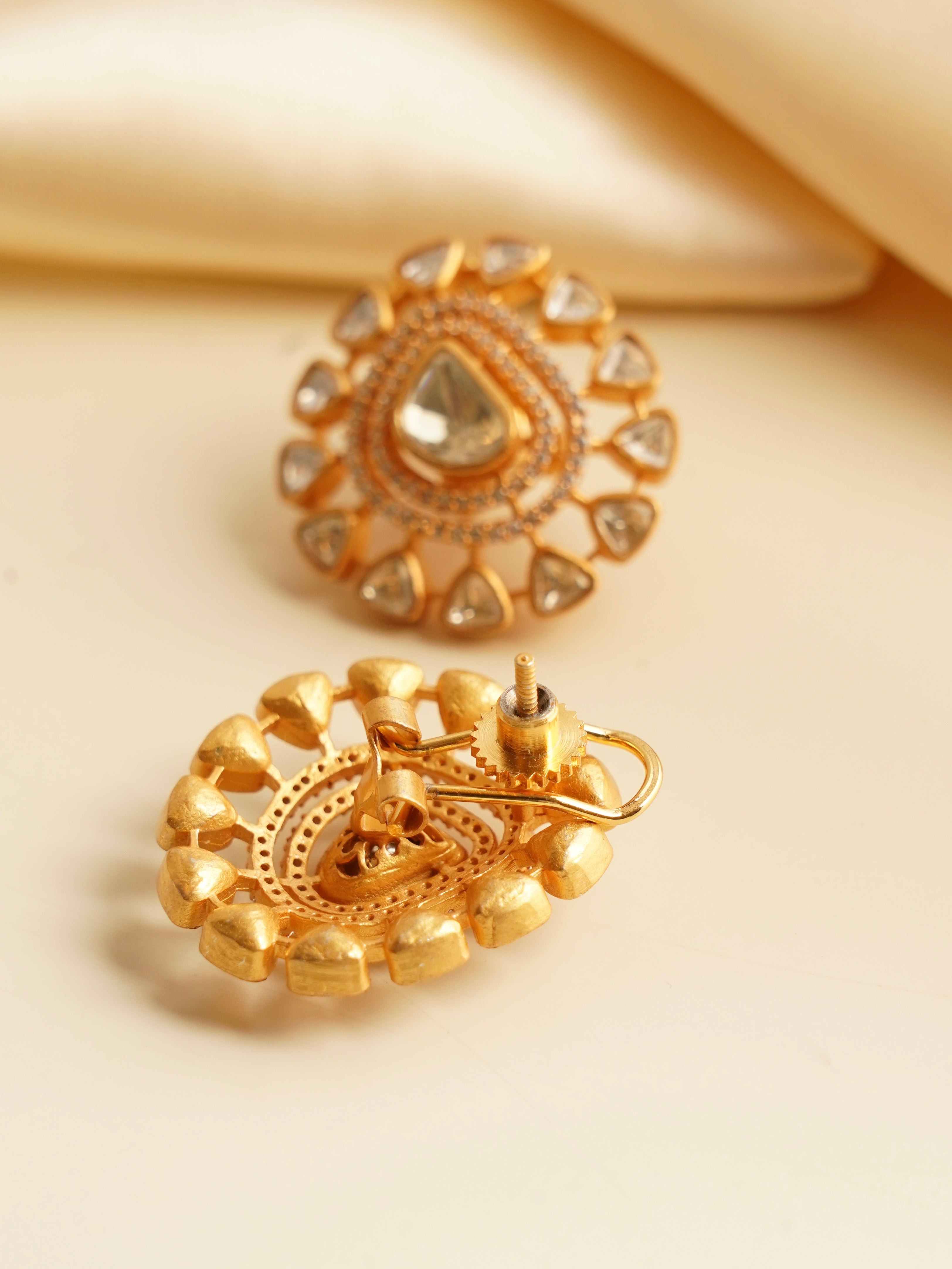 Angled view of moissanite polki studs with traditional gold setting and smooth finish