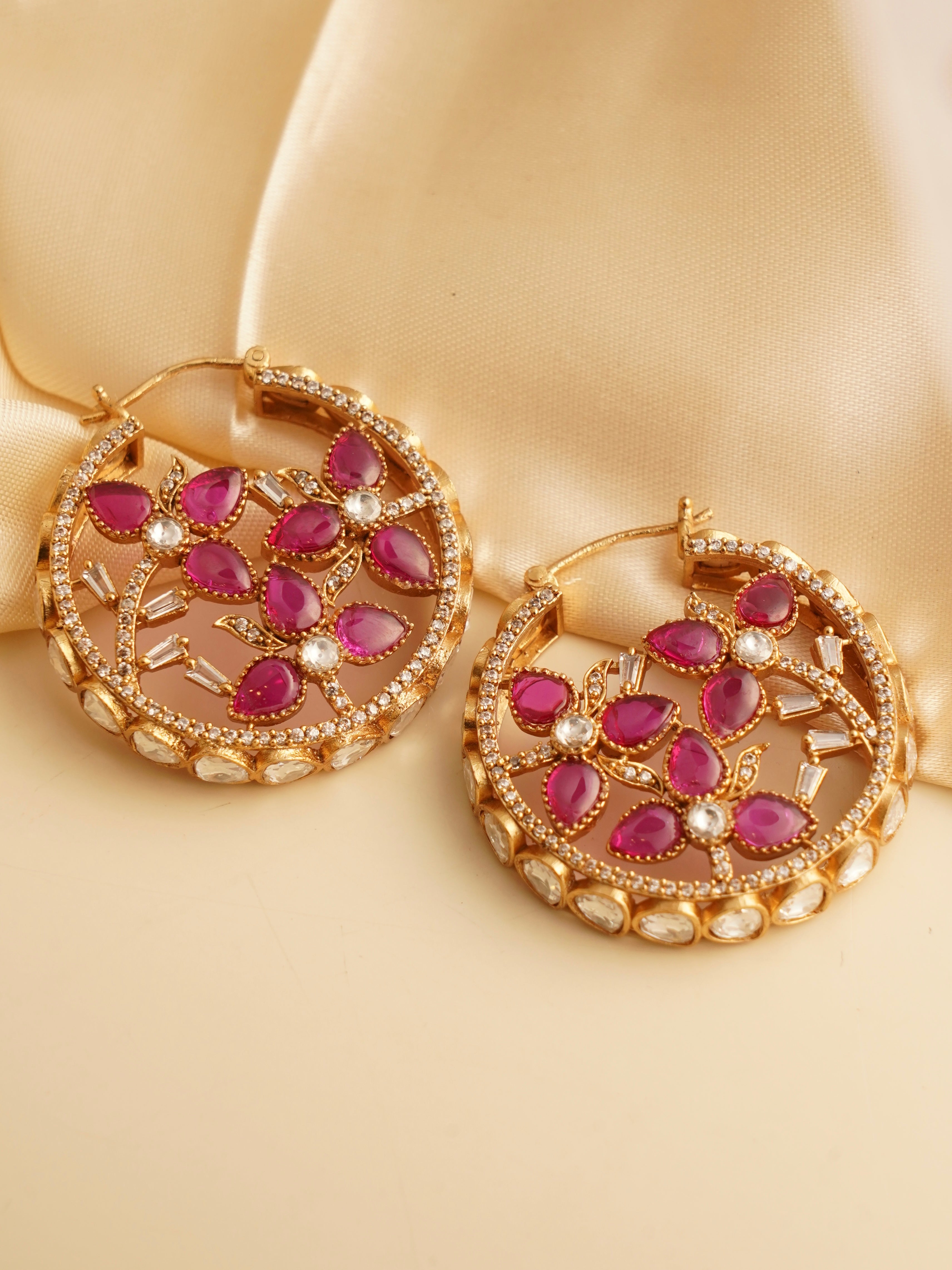 Front view of pink petal hoops featuring crystal embellishments and gold-toned finish, 4.5 cm length