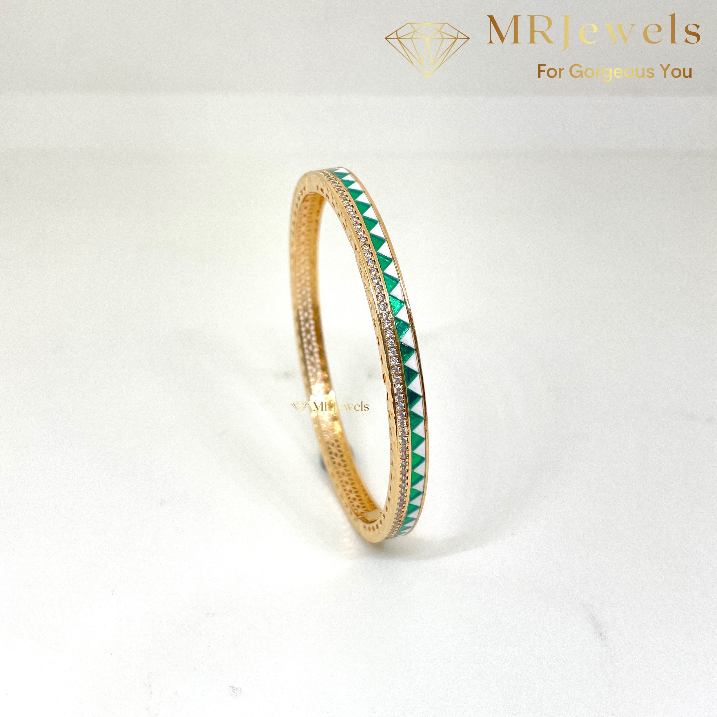 Side angle showing dual enamel pattern and CZ stonework on designer bracelet