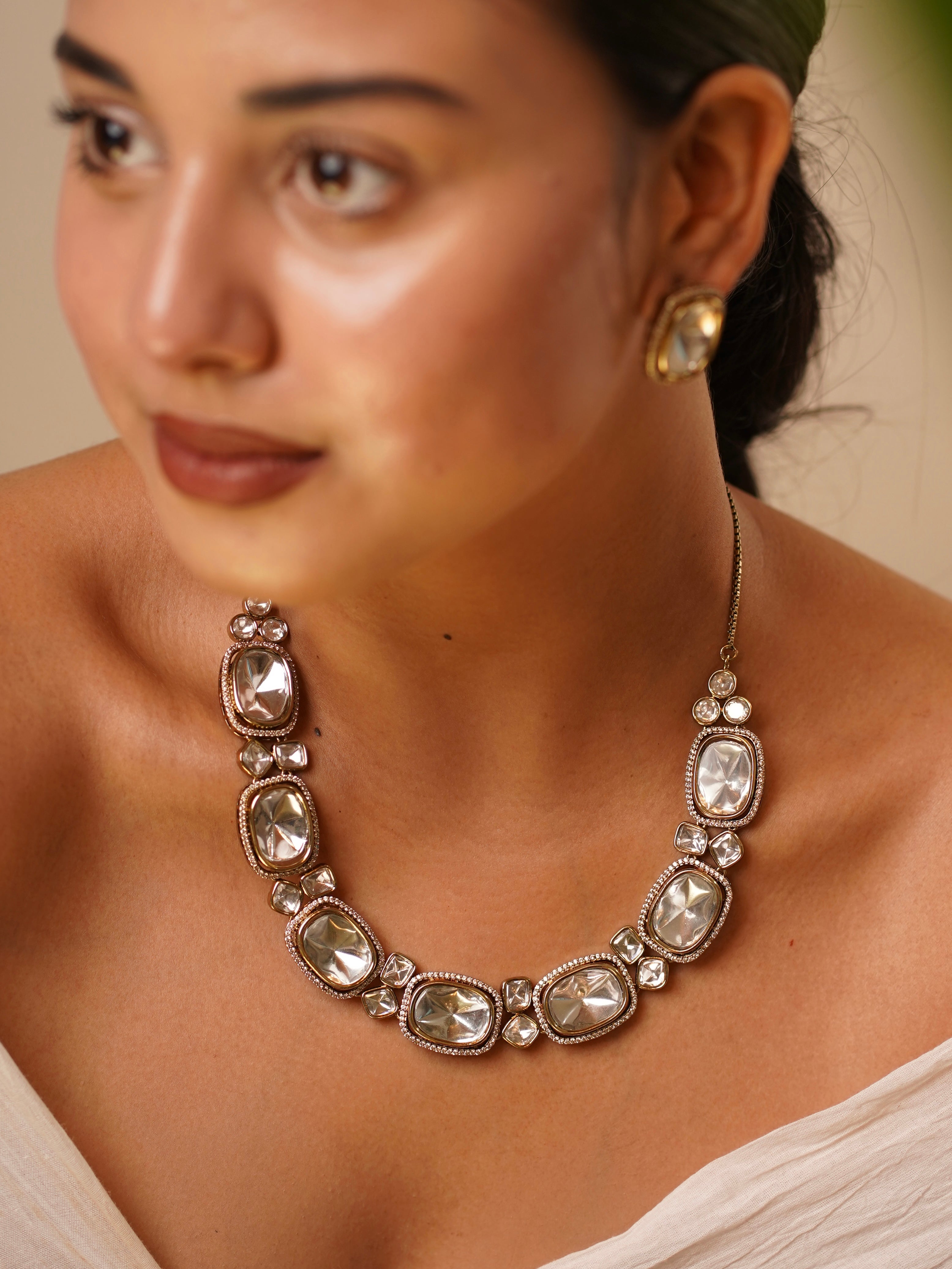 Flat lay of kundan jewellery set with imperial stone arrangement and maangtikka