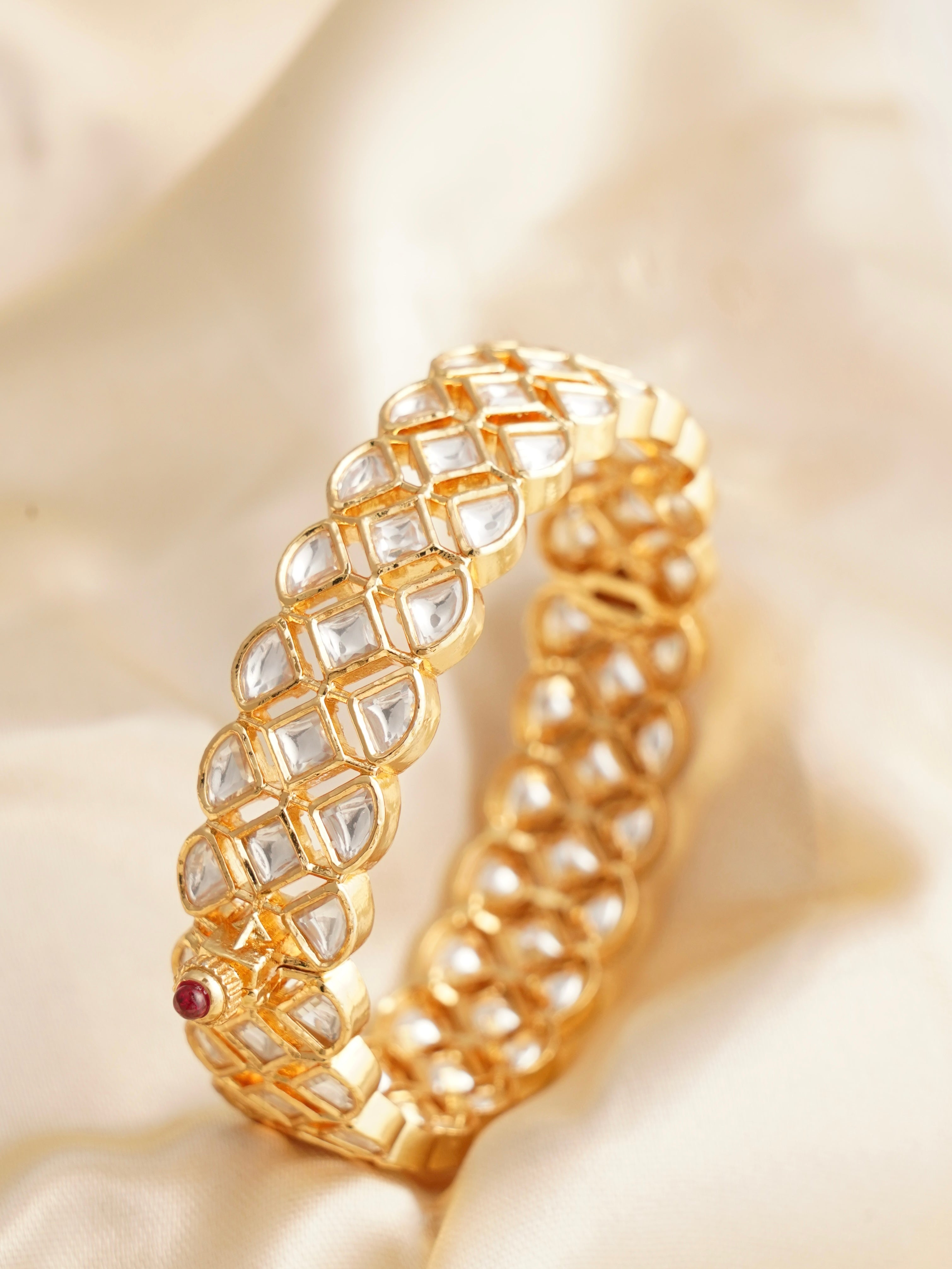 Side view of kundan-studded kada bangle with gold plated finish