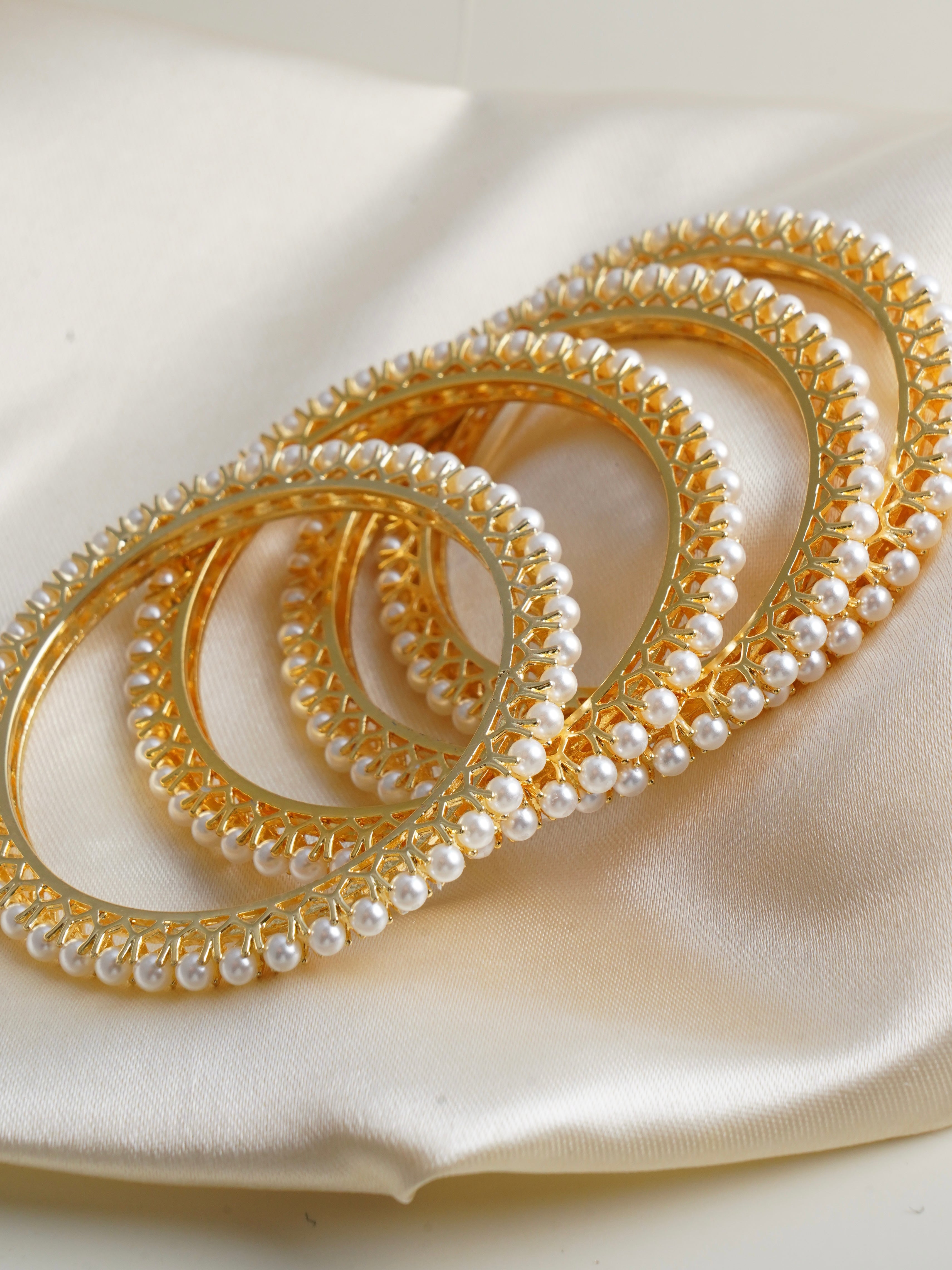 Classic pearl elegance bangles in gold finish with open lattice design and delicate pearl detailing
