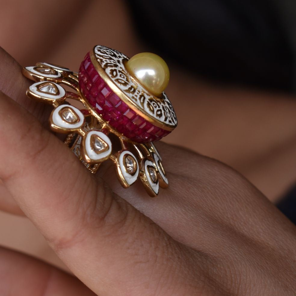 majestic pearl ring with gold filigree and sparkling stone halo on neutral backdrop