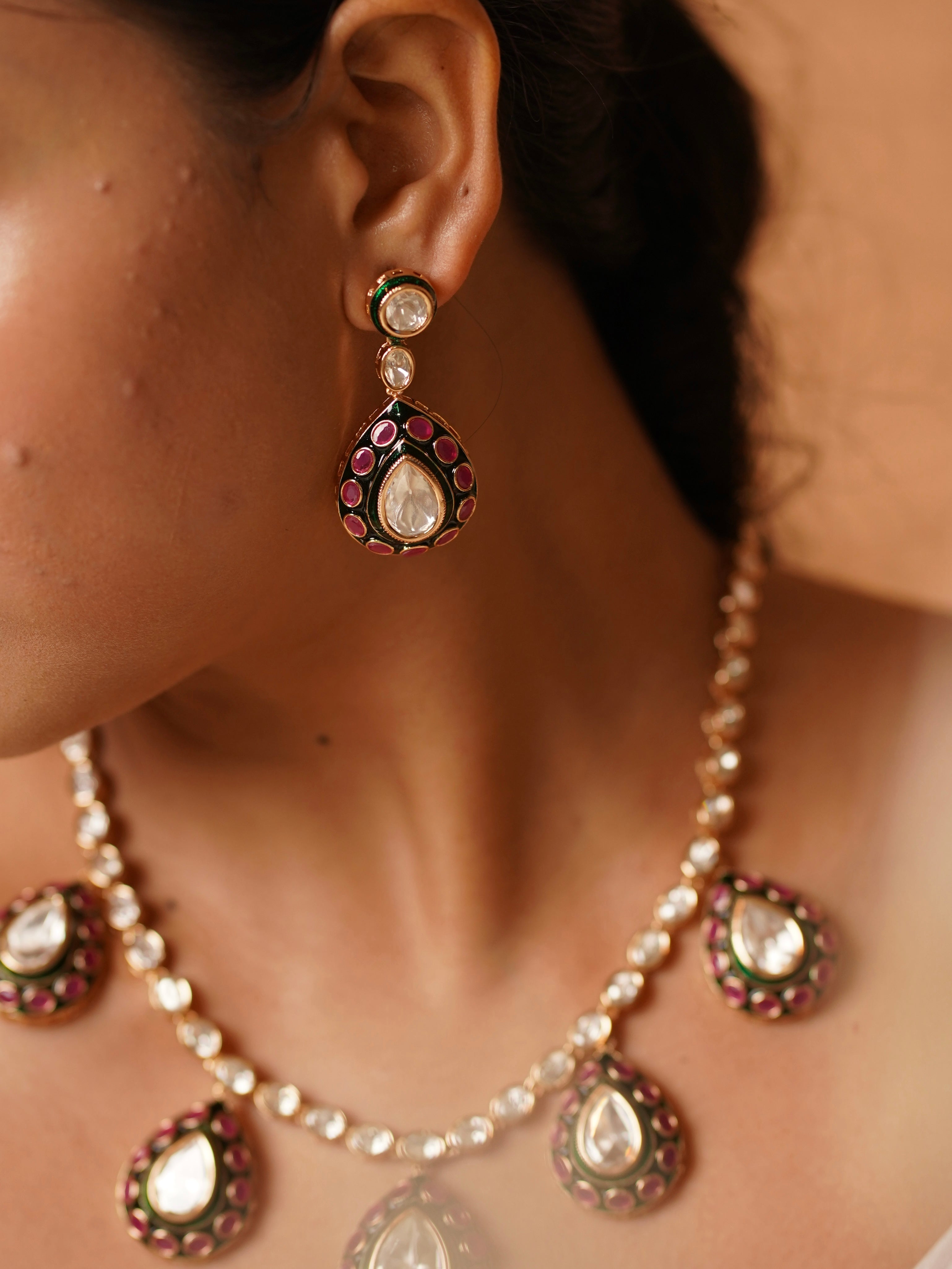 Close-up of Aisha necklace showing uncut stones and teardrop meenakari pendant
