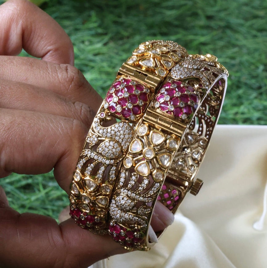 Side angle of kundan bangles showing gemstone detailing and polished gold finish