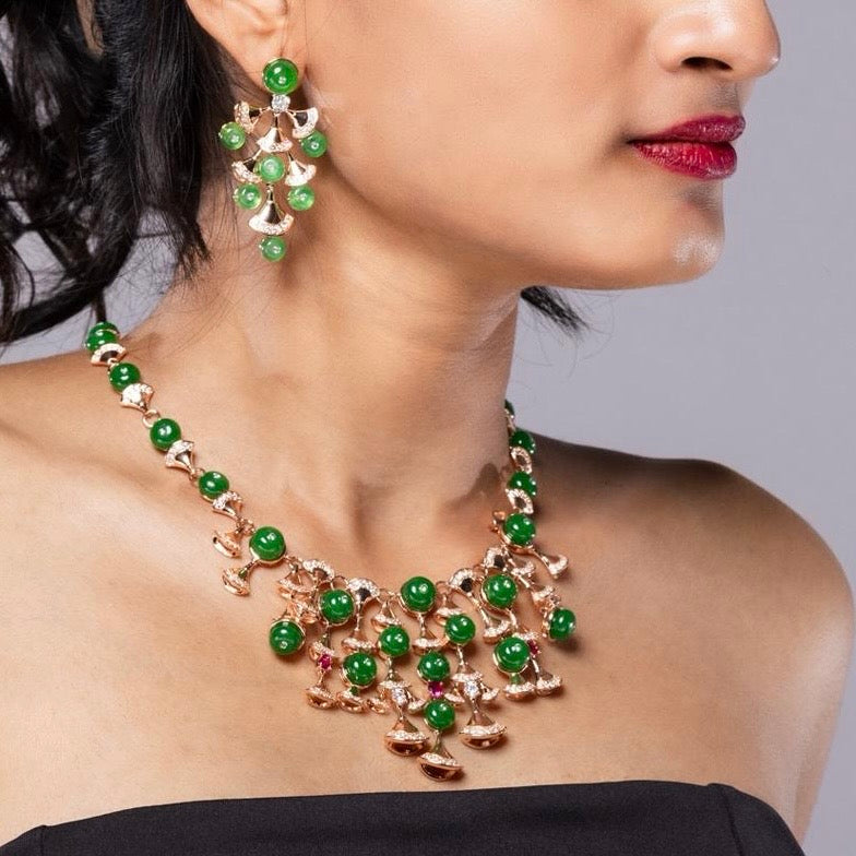 Emerald gemstone necklace with matching earrings in heritage-style design, front angled view