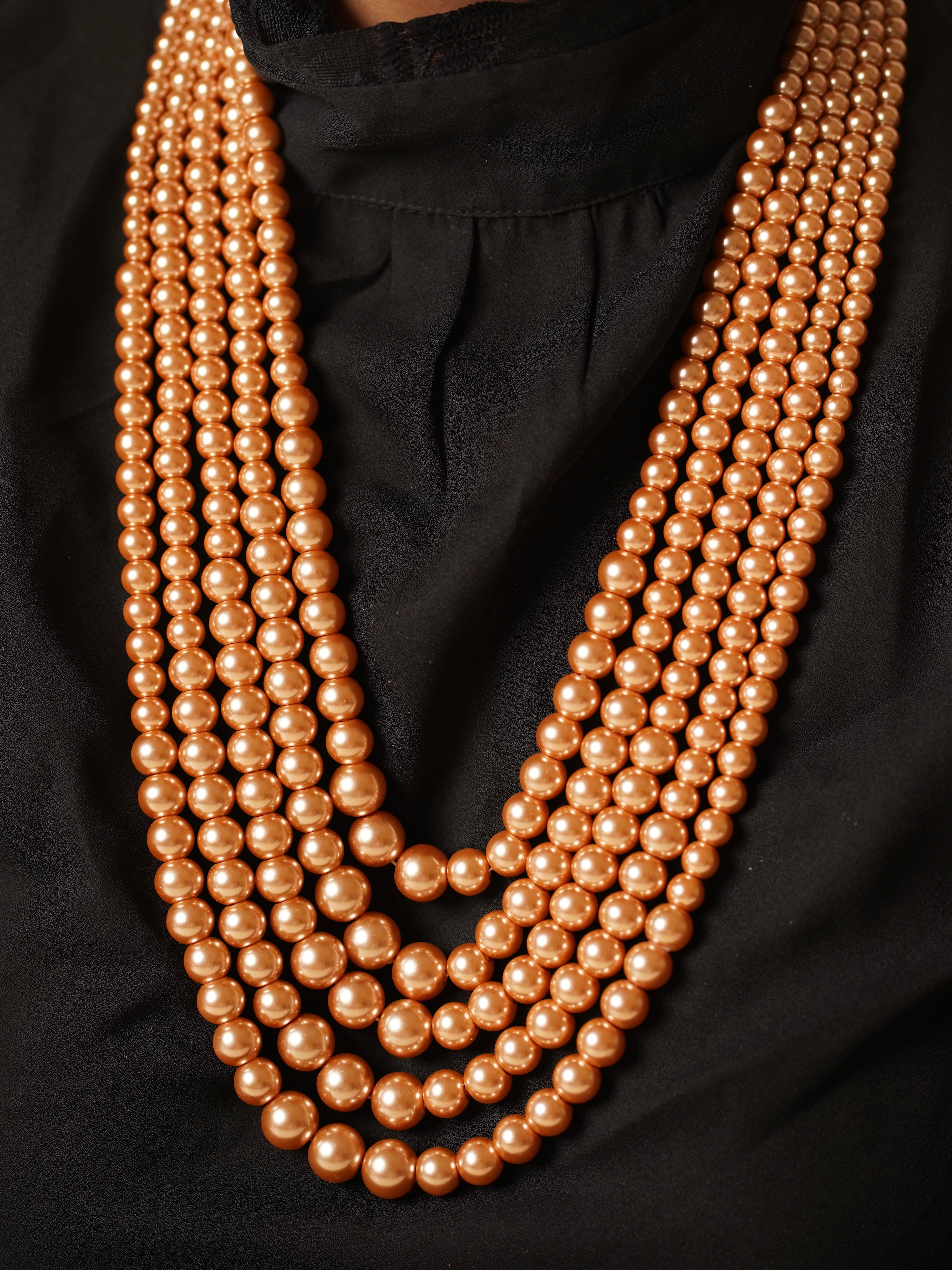 Side view of five-string pearl necklace showcasing lustrous beadwork