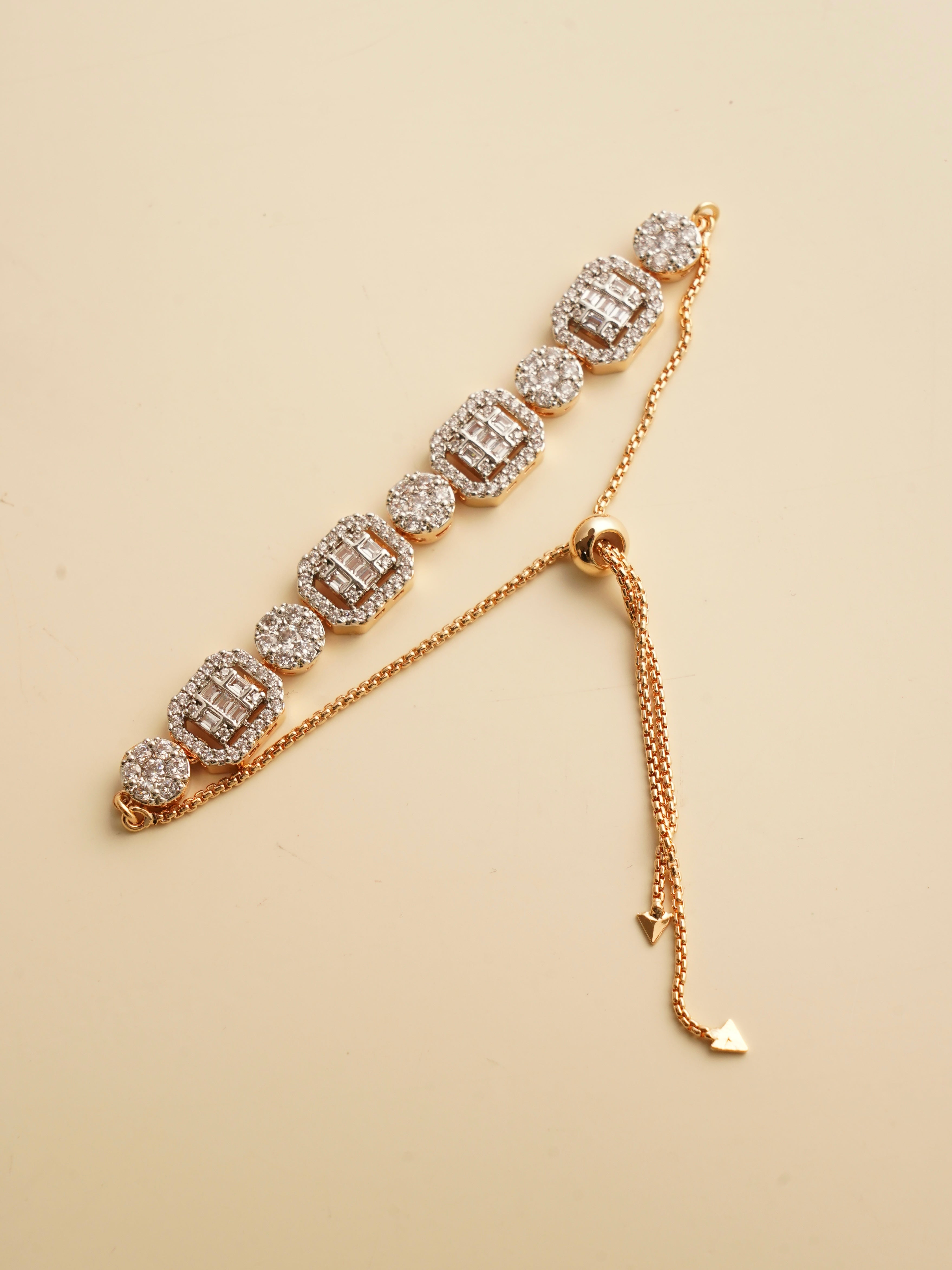 Rose gold adjustable bracelet featuring baguette and round-cut zircon clusters and sliding chain closure