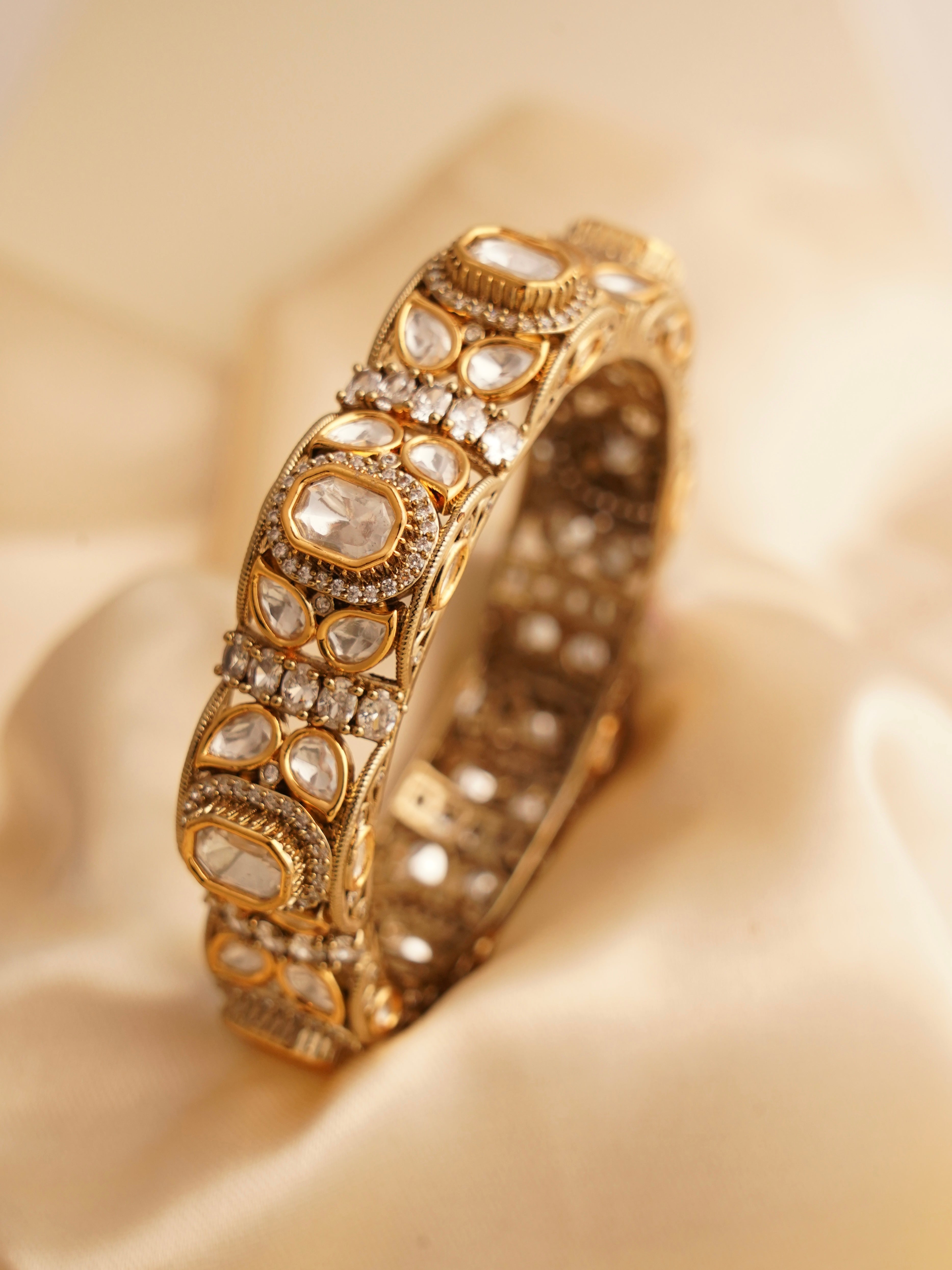 Handcrafted kundan polki bangles with uncut stones, meenakari detailing, and antique gold polish