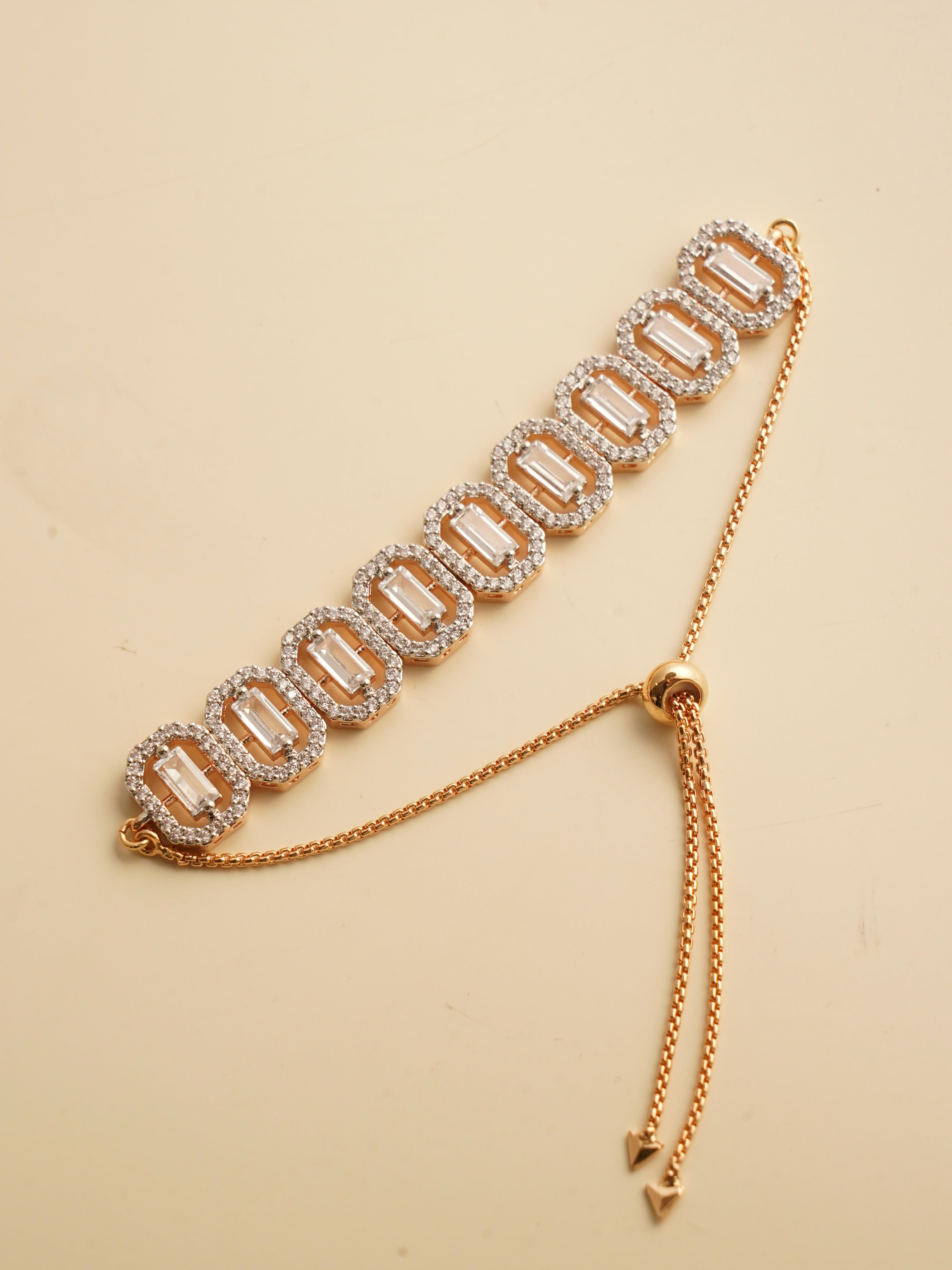 Celestia baguette radiance bracelet with rectangular baguette stones, zircon halo links and rose gold sliding clasp