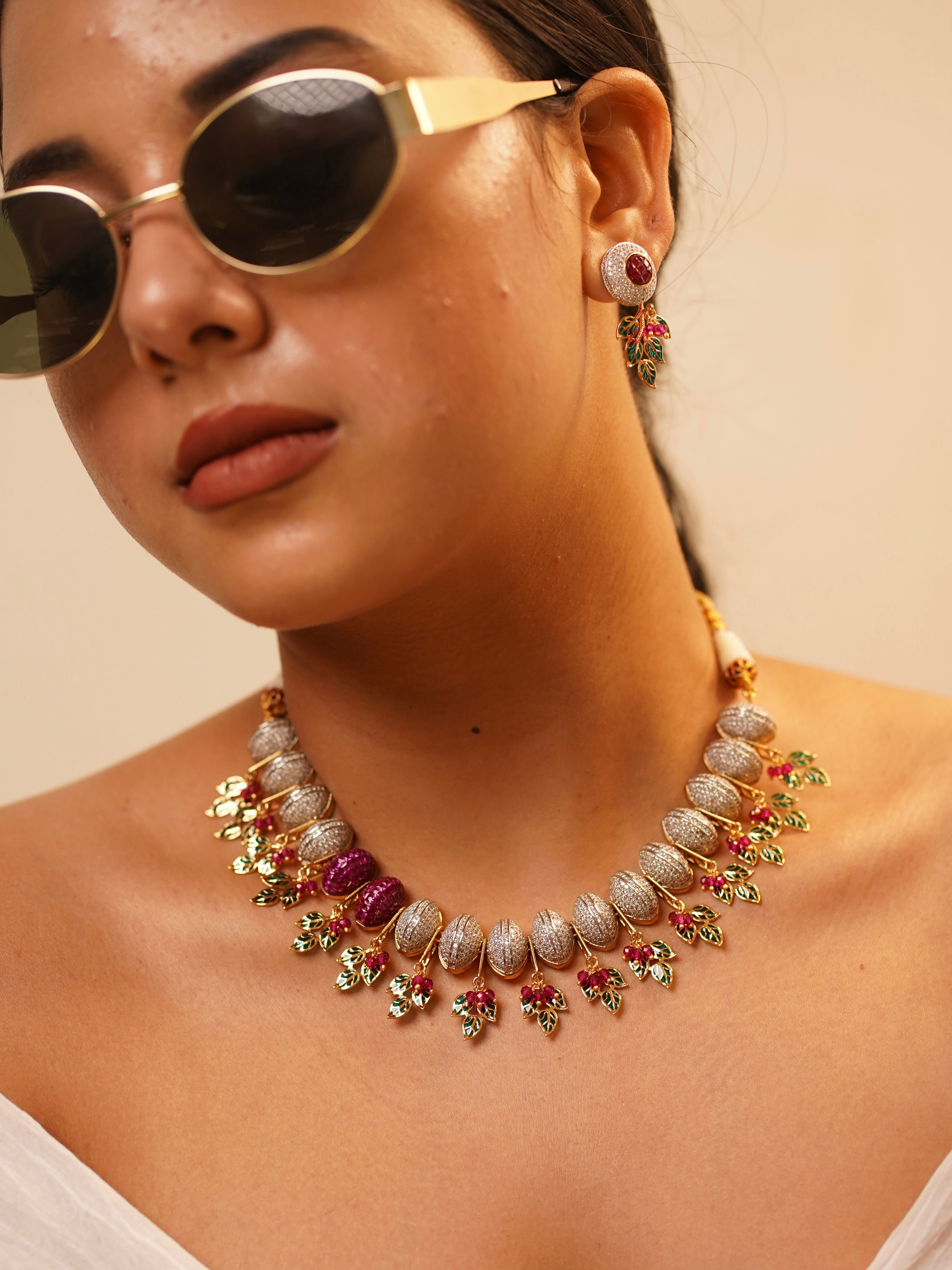 Ruby and diamond necklace with carved gemstones and gold leaf detailing