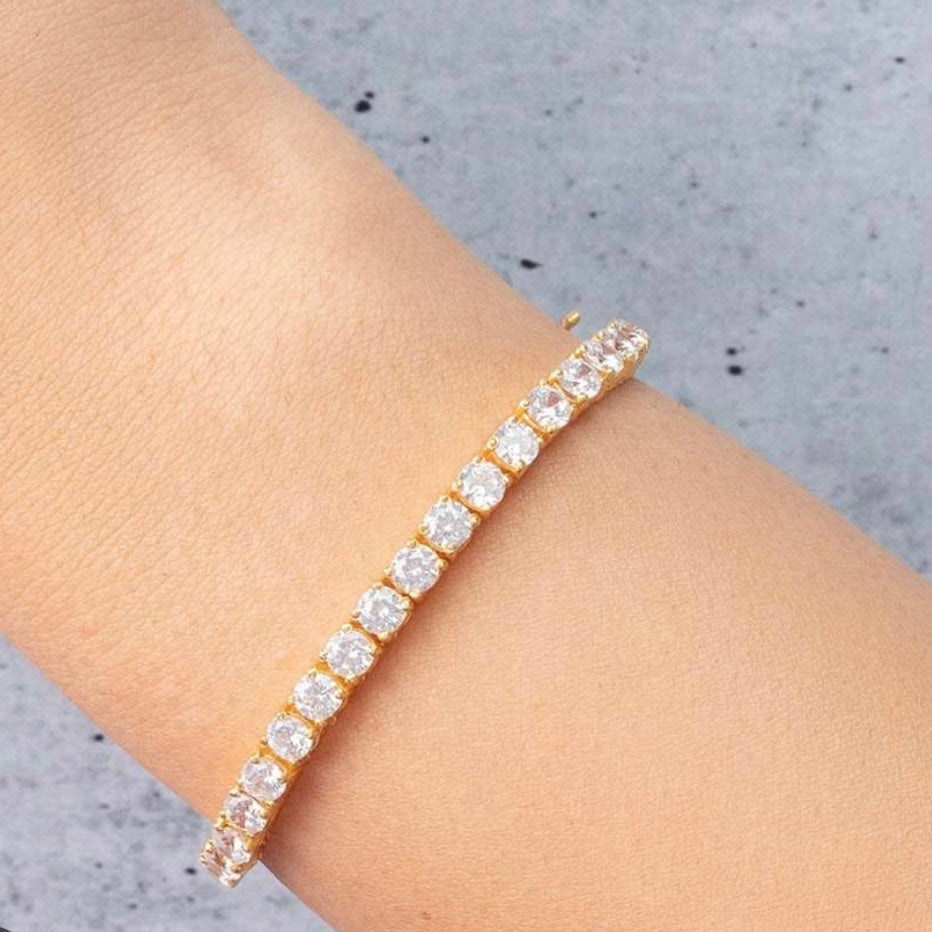 Angled view of tennis bracelet showing sparkle and slim gold chain design